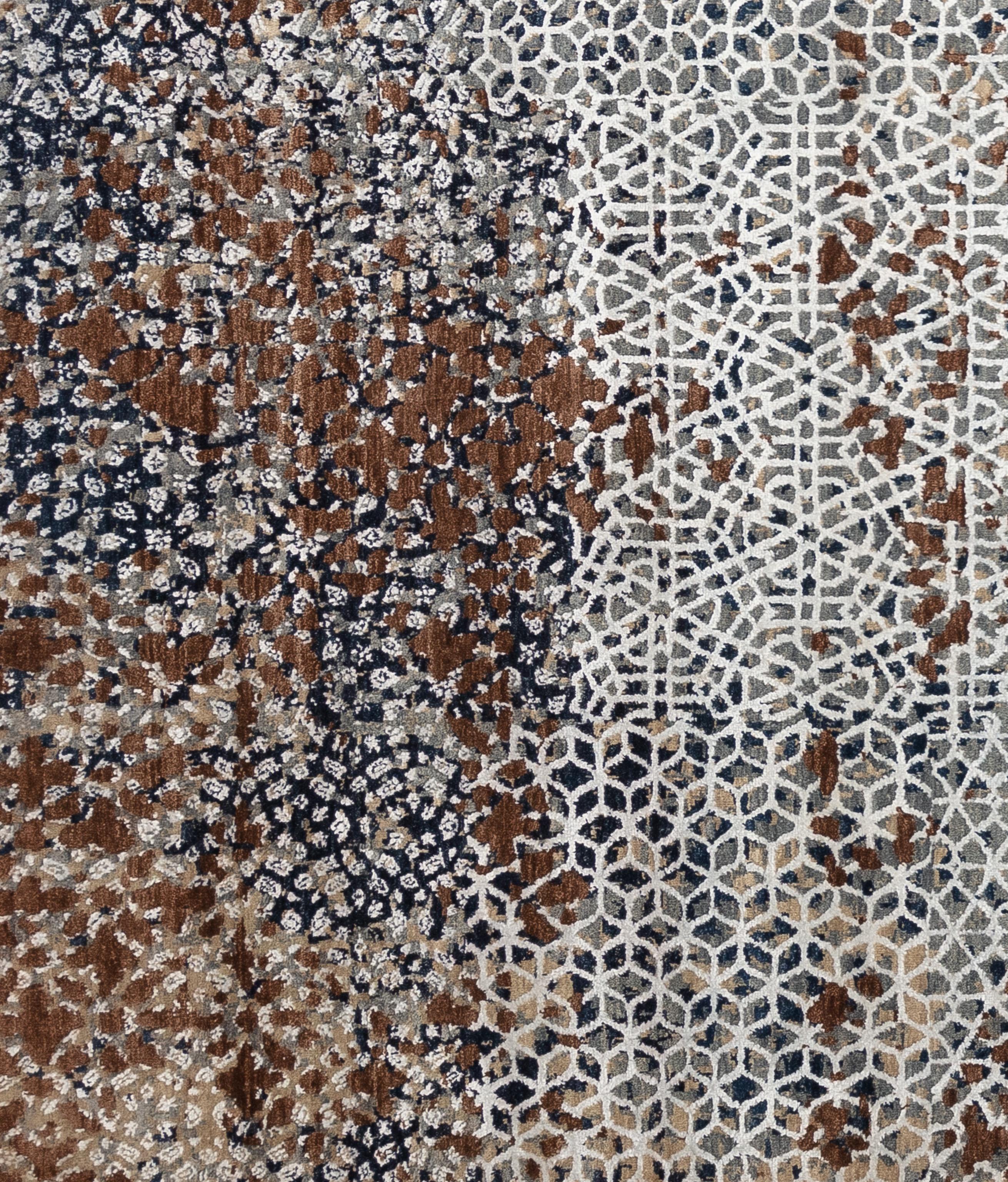 This abstract, modern contemporary rug, is hand-woven by India's finest and made of 100% handspun wool and silk. Its unique earthy pallet features navy blue, ivory and sand, chestnut and greys. The kaleidoscope like motif throughout adds dimension