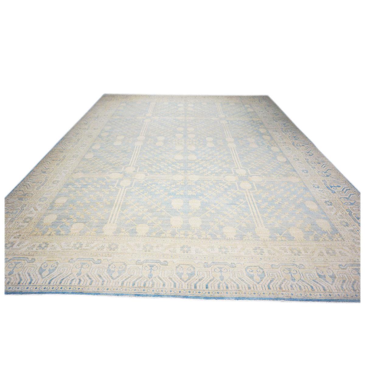This 21st Century Afghan Khotan Wool Handwoven 11x14 Ivory & Light Blue rug is made of 100% hand-twisted wool fibers which were vegetable dyed with subtle colors. The background is light blue and the design, details, and border include light blue,