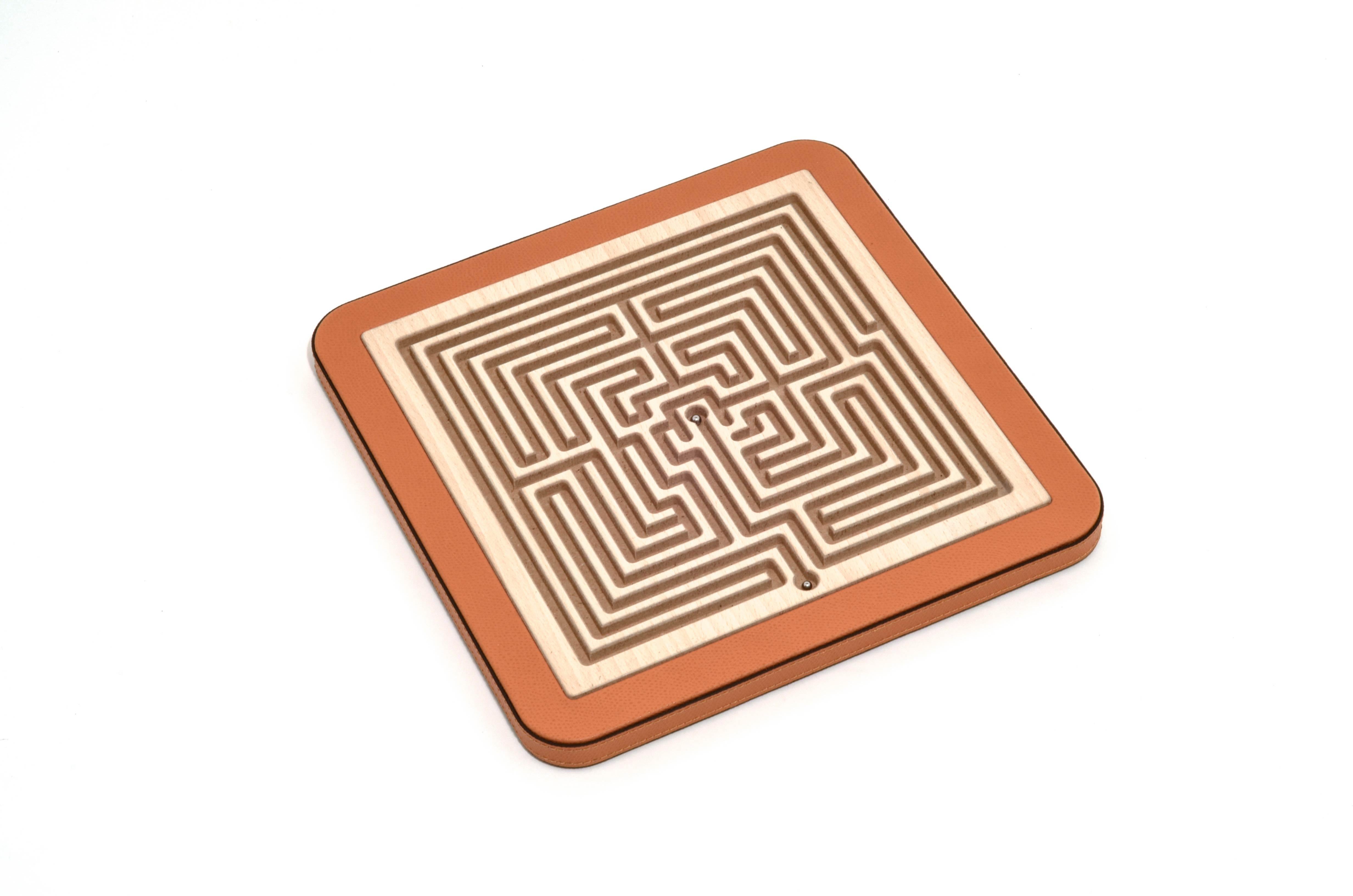 A perfect addition for your game room or the ideal luxury gift?
The choice is yours!

Arianna, our new wooden square maze is laser cut and finished in genuine leather. Its lines and contrasts make up its labyrinthine structure to create a