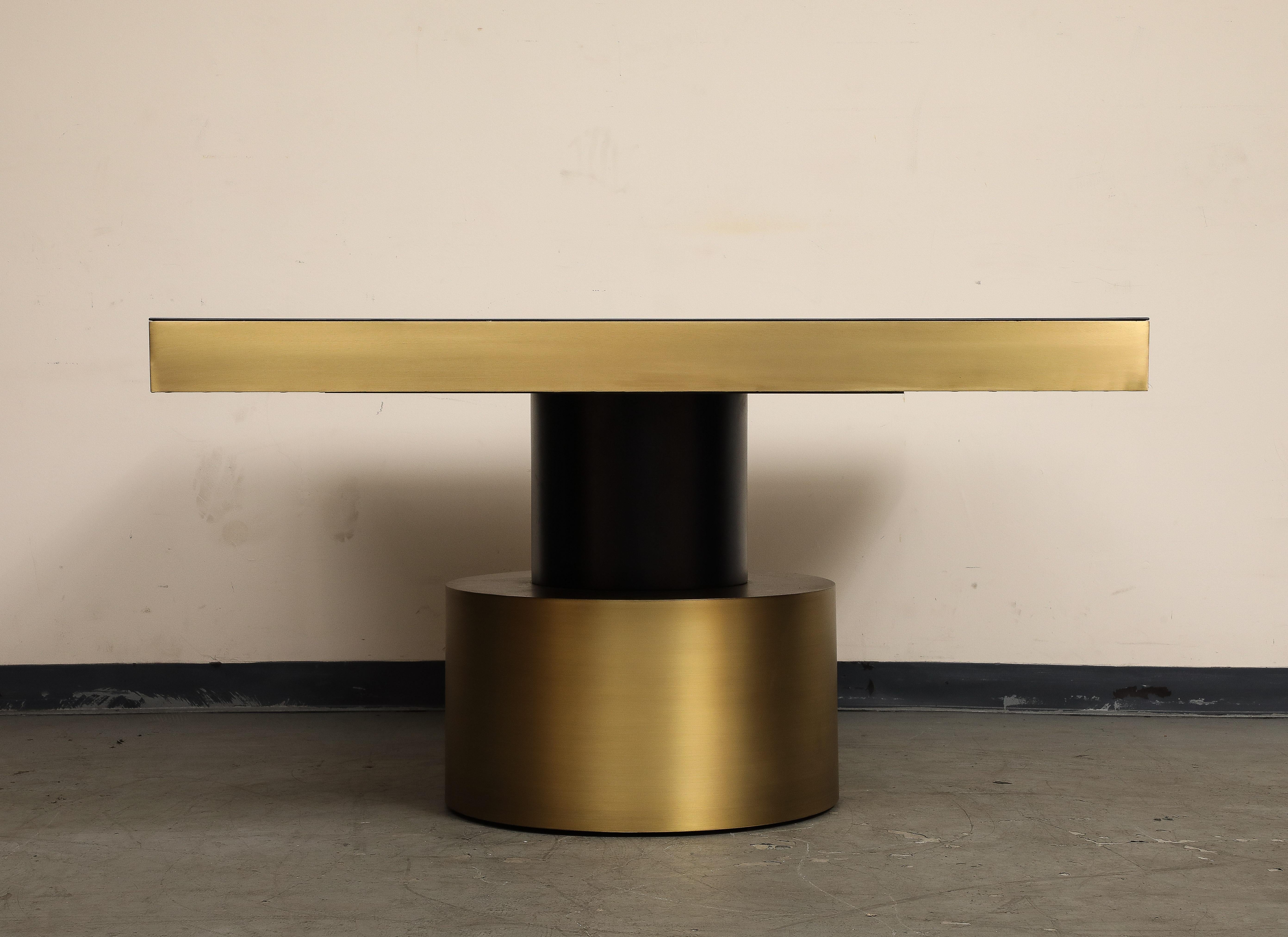 21st Century Art Deco Antique Brass and Black Lacquered Wood Rio Dining Table, pre-owned, was custom made with a square top. 

The Rio dining table is a truly unique piece of furniture that exudes tropical, sexy style. Crafted from the highest
