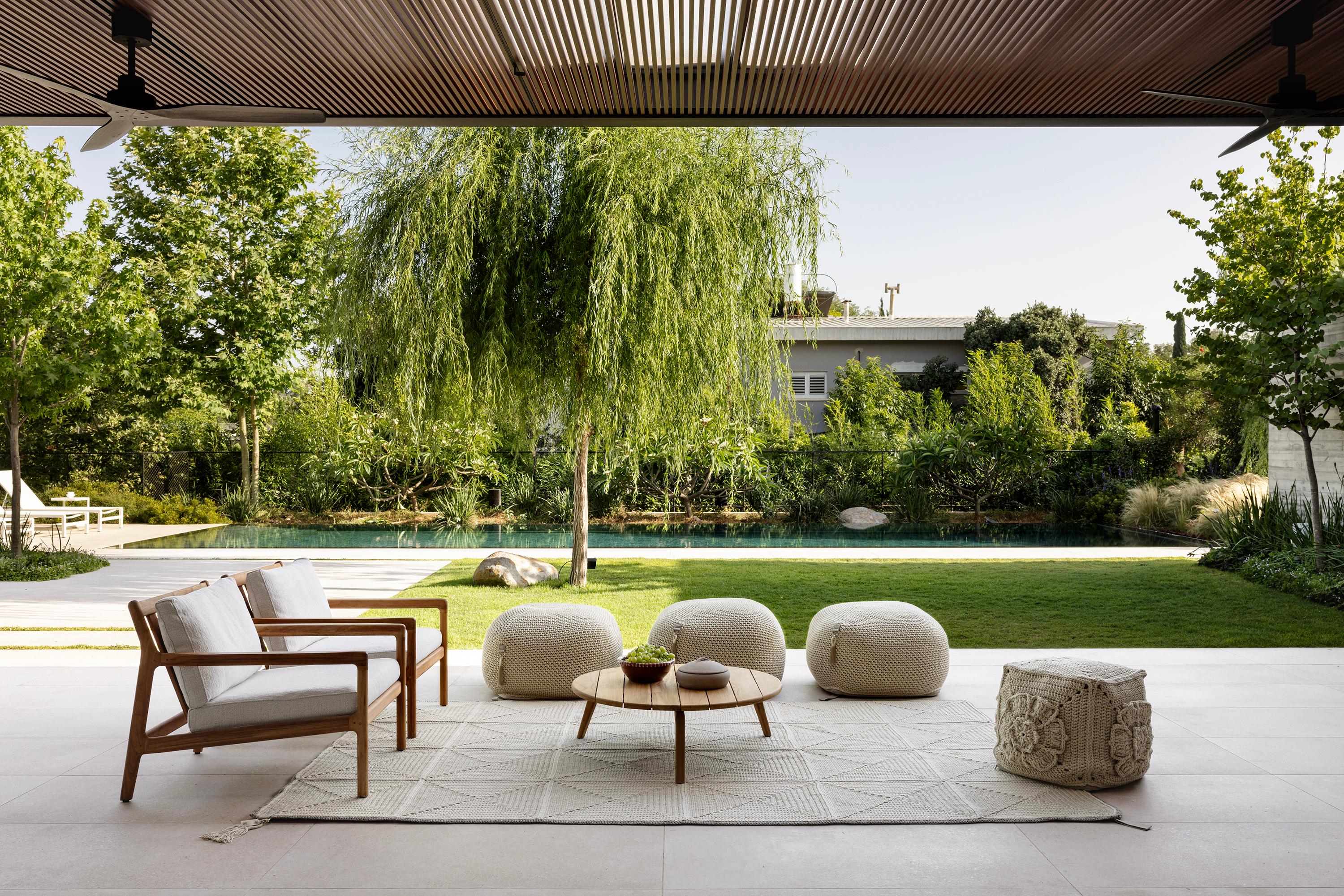 The Classic crochet granny square takes a contemporary twist in this outdoor rug. Large squares form the rug, framed with bespoke webbing. Handmade from UV protected bespoke iota yarn in earth tones, the textile is soft, yet durable and suitable for