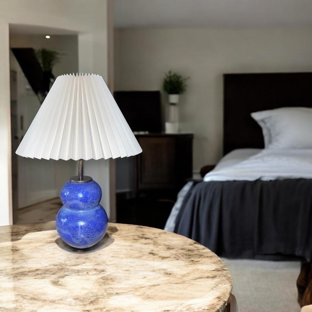 The Azure Lamp embodies the elegance of modern design, gracing living spaces with its deep blue hues and sophisticated presence. With its minimalist structure and captivating form, the Azure Lamp serves as both a functional light source and a work