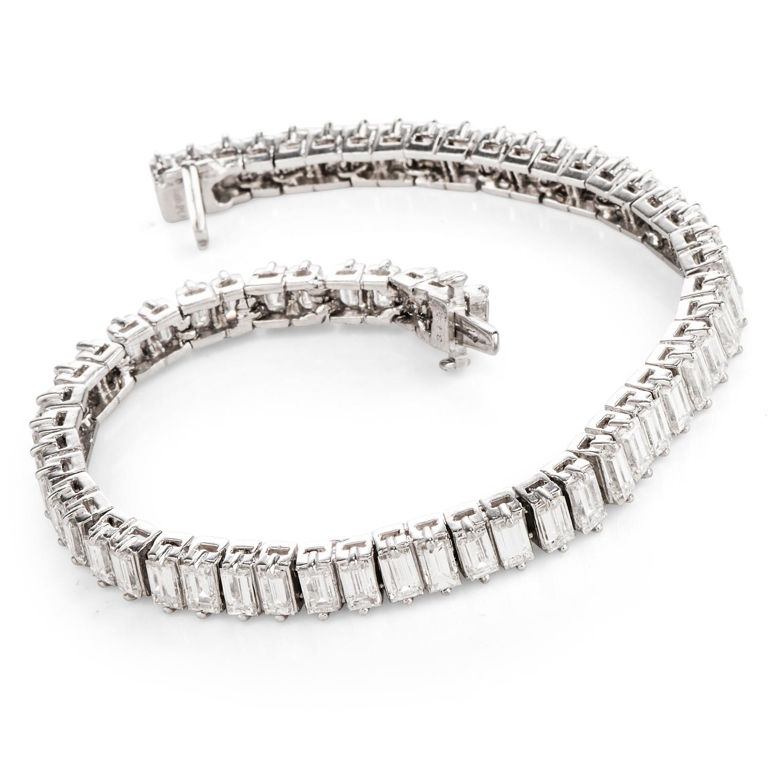 This stunning diamond tennis bracelet is crafted in solid platinum, weighing 21.3 grams and measuring 6 ¾ inches around the wrist x 5mm wide. Composed of 61 high quality prong-set, baguette diamonds, collectively weighing approximately, 14.08