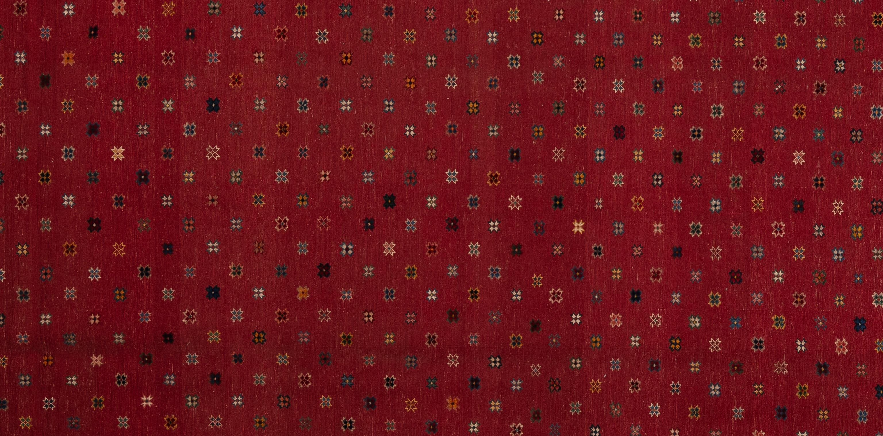 Embrace the allure of nomadic artistry with this authentic Baluch rug. Crafted by skilled artisans, each knot tells a story of tradition and heritage. Woven with intricate geometric patterns and rich tones, it brings a touch of rustic charm to any