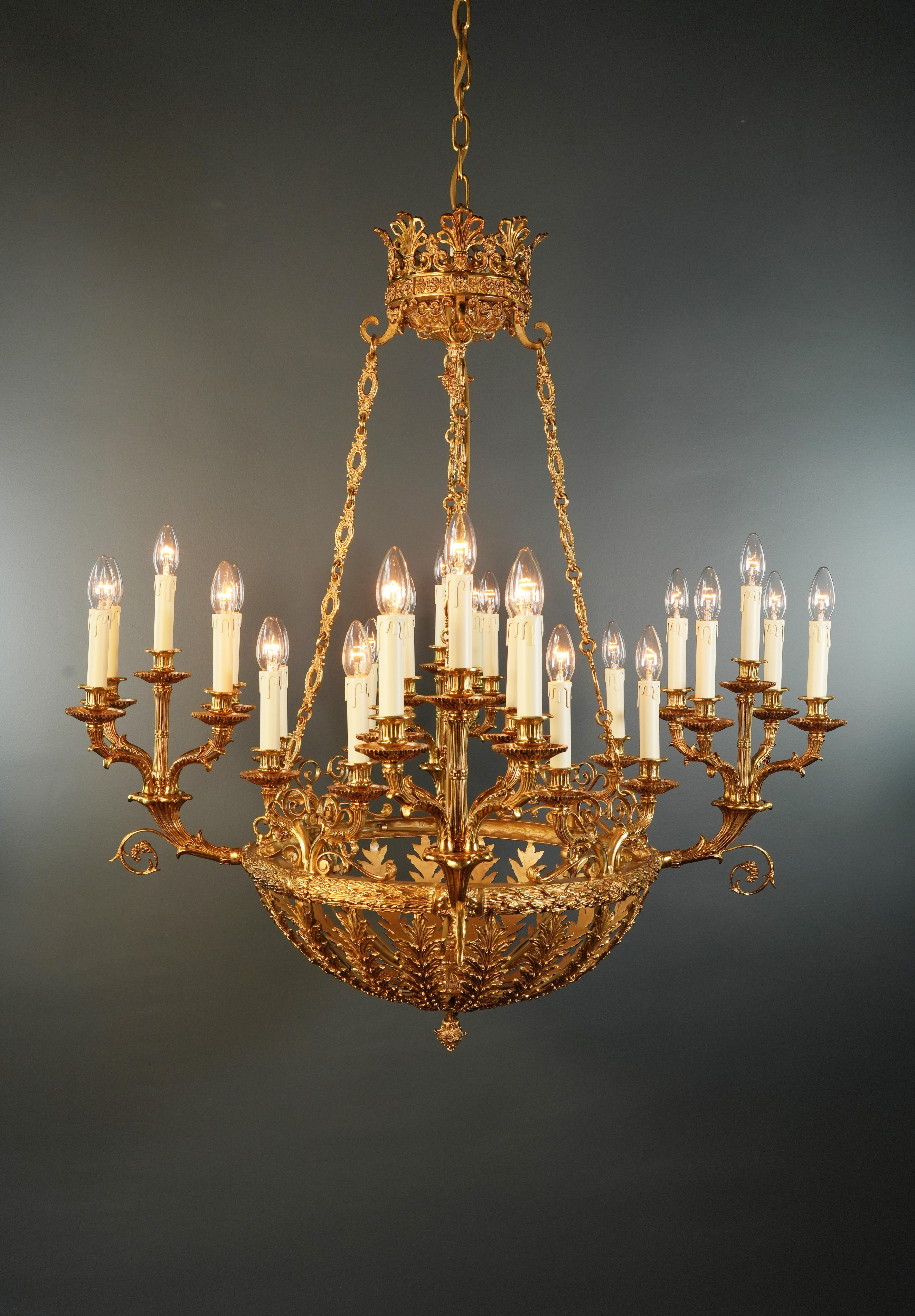 Introducing a stunning Baroque Empire brass chandelier, an exquisite piece with fascinating embellishments reminiscent of the classic style of the Empire era. This is a new reproduction and there are several available to ensure you can bring this