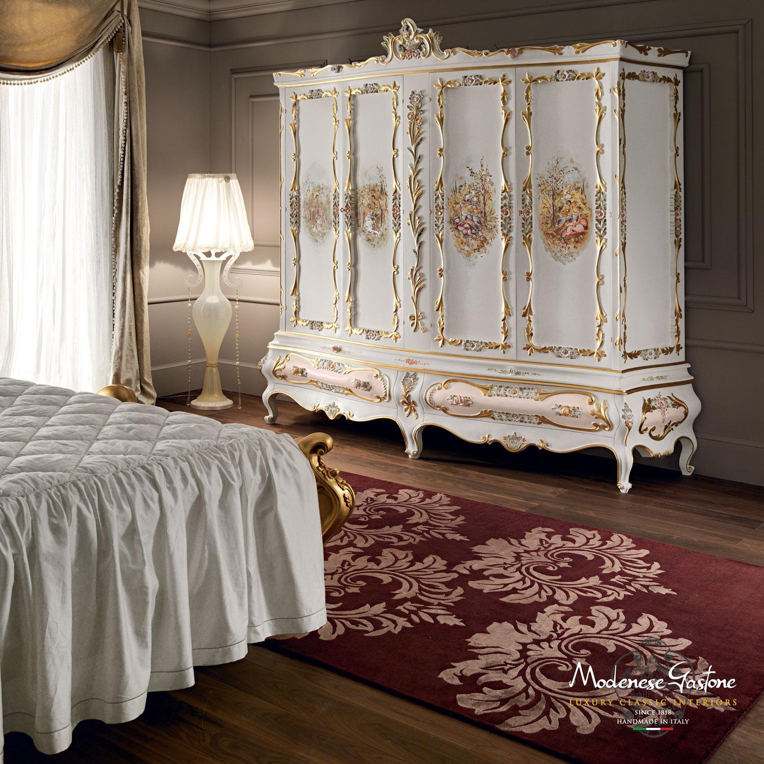 Complete your lavish classical bedroom with an exclusive Italian baroque touch by adding this Modenese Interiors masterpiece: four door wardrobe with handpainted artisanal decorations, squiggle carvings and gold leaf applications. The venetian