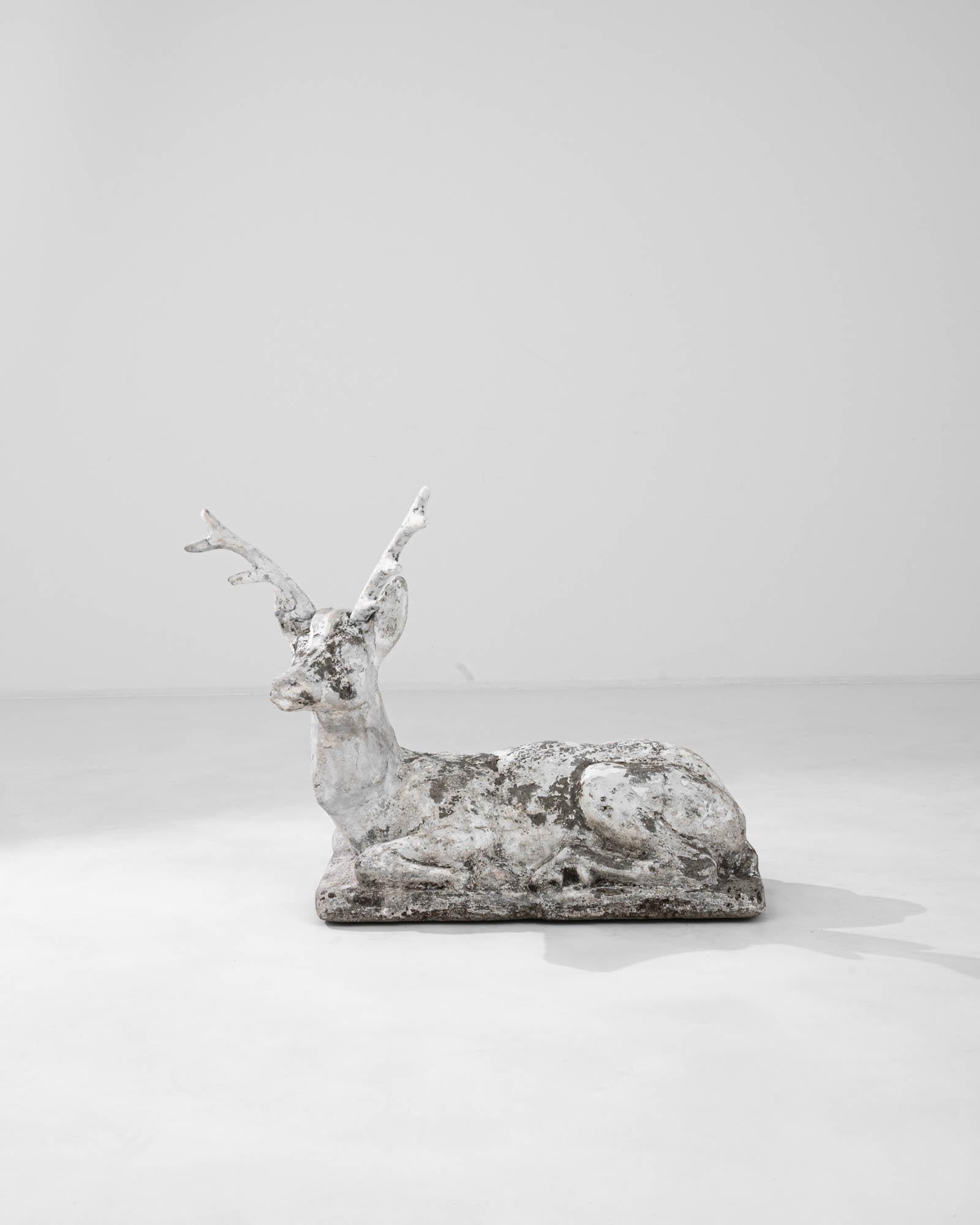 This 20th Century Belgian concrete deer sculpture captures the essence of nature with its rustic charm and lifelike presence. Exuding a sense of tranquility and grace, the sculpture showcases a weathered texture, hinting at stories of the past. The