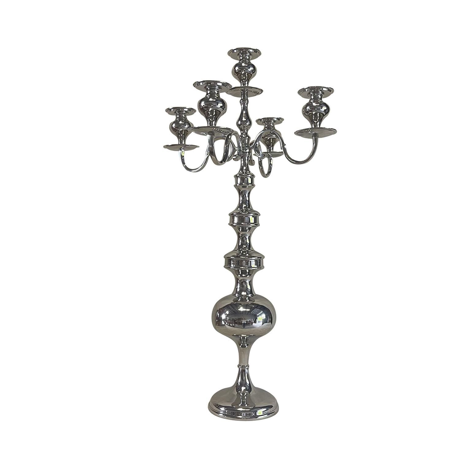 A pair of very tall romantic floor candelabras made of hand crafted nickel, each of them is composed with a five candle cup holders. The long lobed bases sit on circular floor plates. Wear consistent with age and use. Circa 21st Century,