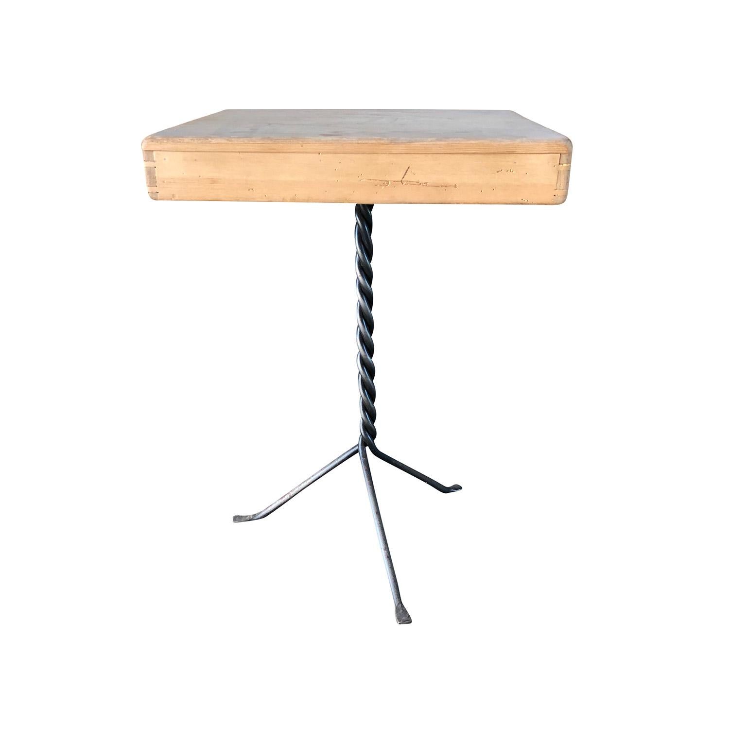 A Belgian side or serving table made of hand crafted Pinewood, in good condition. The thick top of the corner table is supported by a twisted iron beam, resting on three arched legs. Minor fading, scratches due to age. Wear consistent with age and