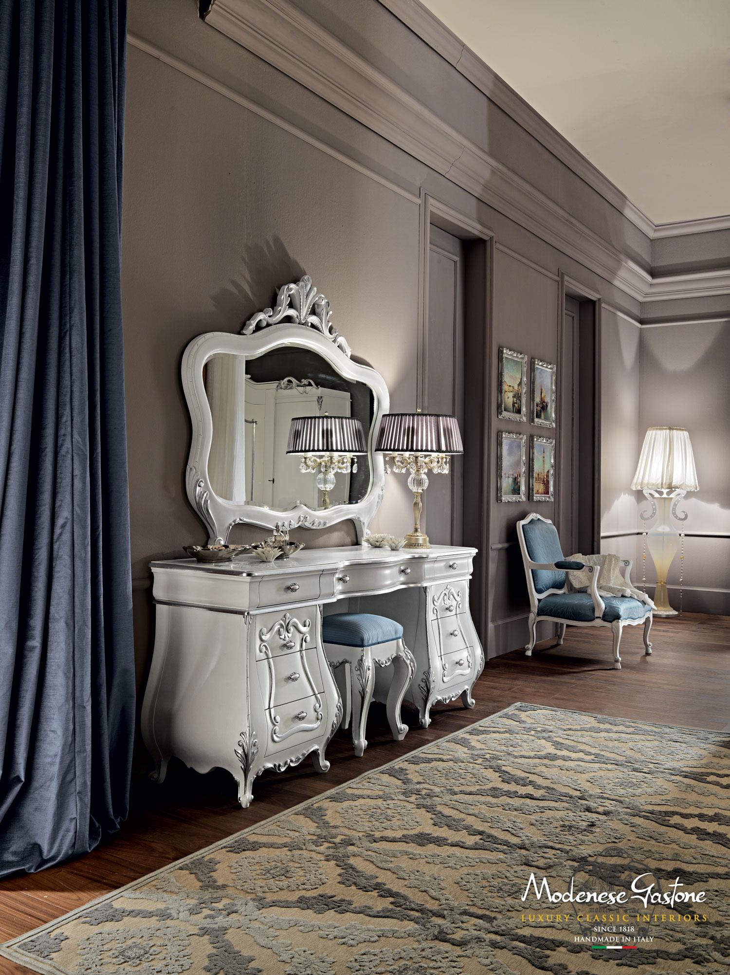Bespoke baroque make-up table by Modenese Gastone Interiors, Italian furniture producer. The unique elegance of this nine-drawer vanity unit is remarcable when we look at its bombed silhouette, the white lacquered finish and the silver leaf