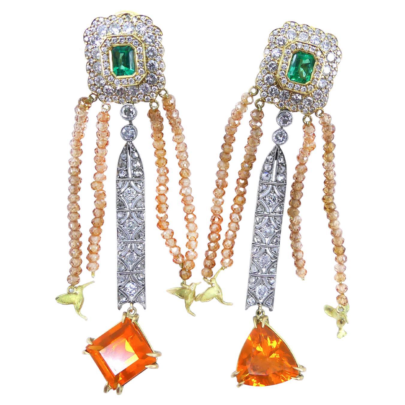 1.1 Carats Emeralds 2.20 Carats Diamonds 6.71 Carats Fire Opals 18 Karat Gold Earrings

Earrings in Bicolor 18 Karat Gold and White Gold, 1.1 Carats in two emeralds, 2.2 carats diamonds on the top of the earring and old cut diamonds. Two fire opals