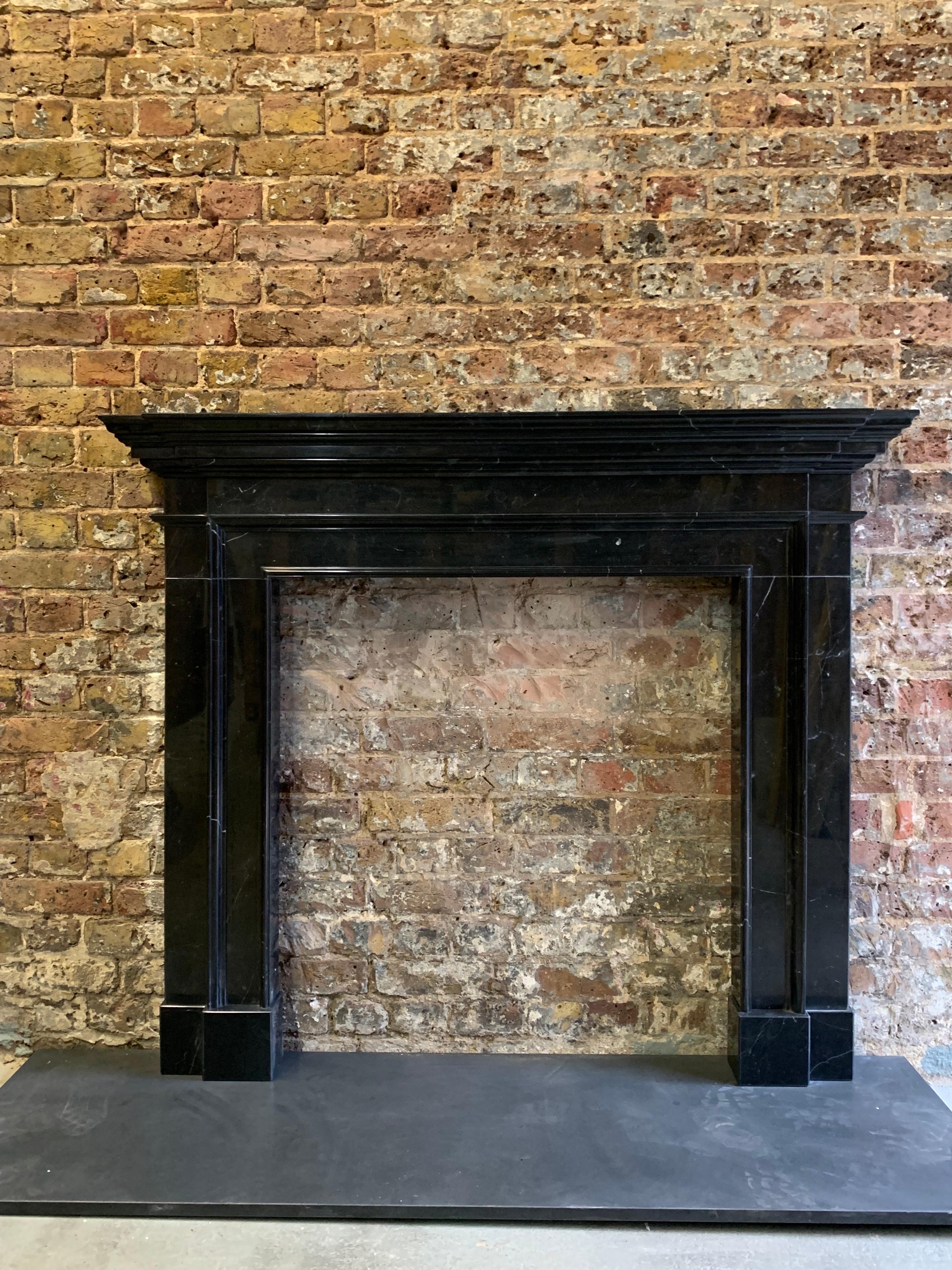 21st Century Black Marble Fireplace Mantlepiece.
Made From Nero Marquina Marble. Hand Carved And Lightly Polished.
Simple Georgian Classic Design.

Dimensions:
Shelf Width 54