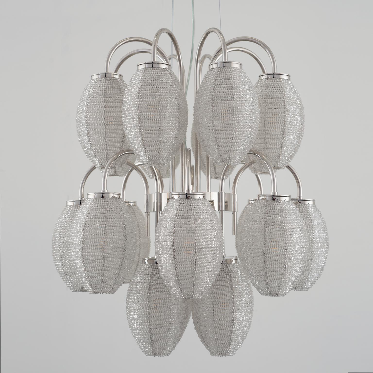 Threethousandsixhundredtwentyeight pearls, one strand. Candid lampshades that remind of precious buds whose design combines the delicacy and the strength of a full bloom together, stopping time a moment before it took place. A way to preserve its