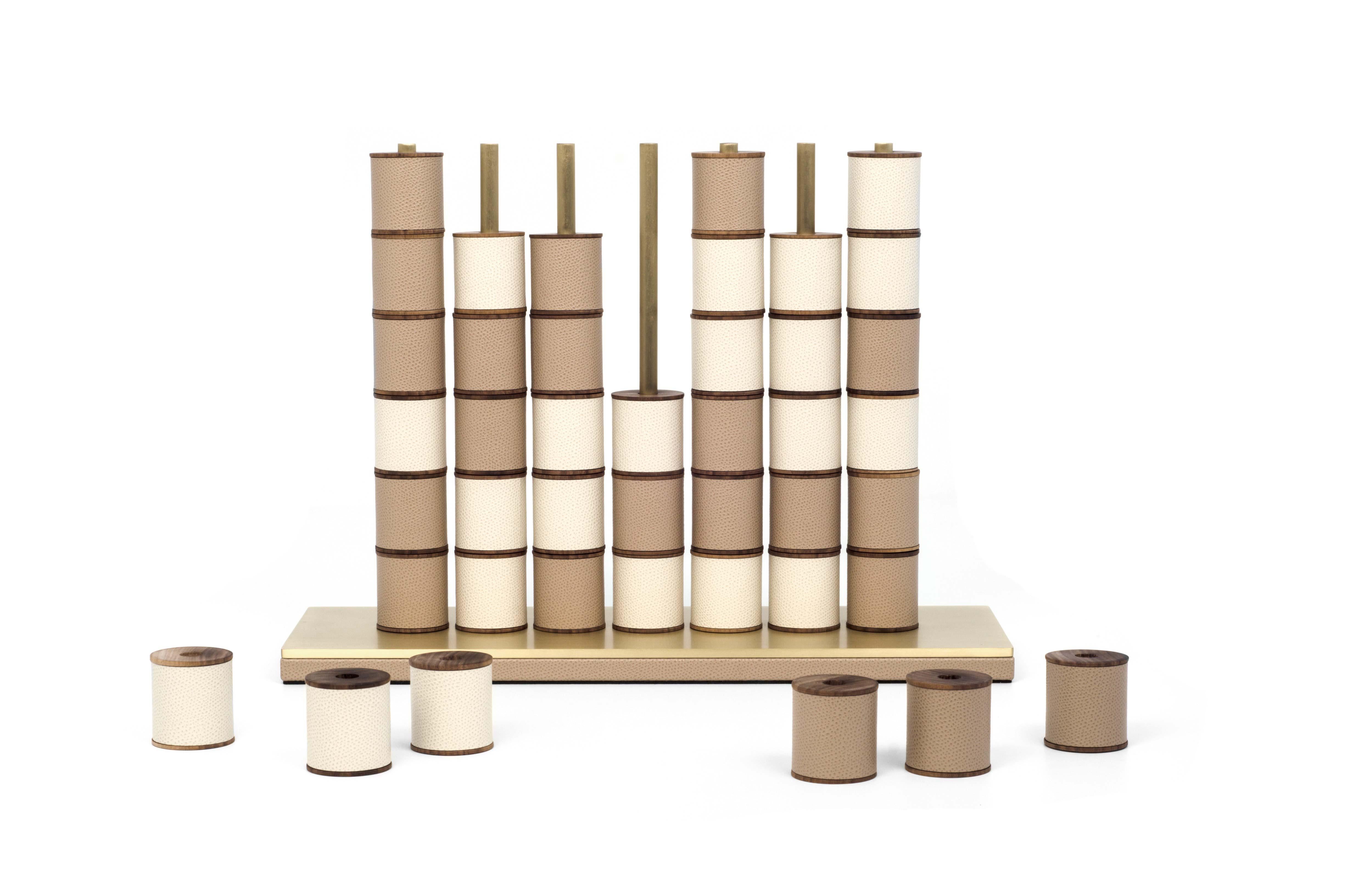 One-of-a-kind set ready for your enjoyment.

Pinetti Connect 4 is something exclusive. Forty two wooden pieces covered in a bicolour soft leather that neatly fit on satin brass bars. Four in a row remain the goal, but we take your game to a