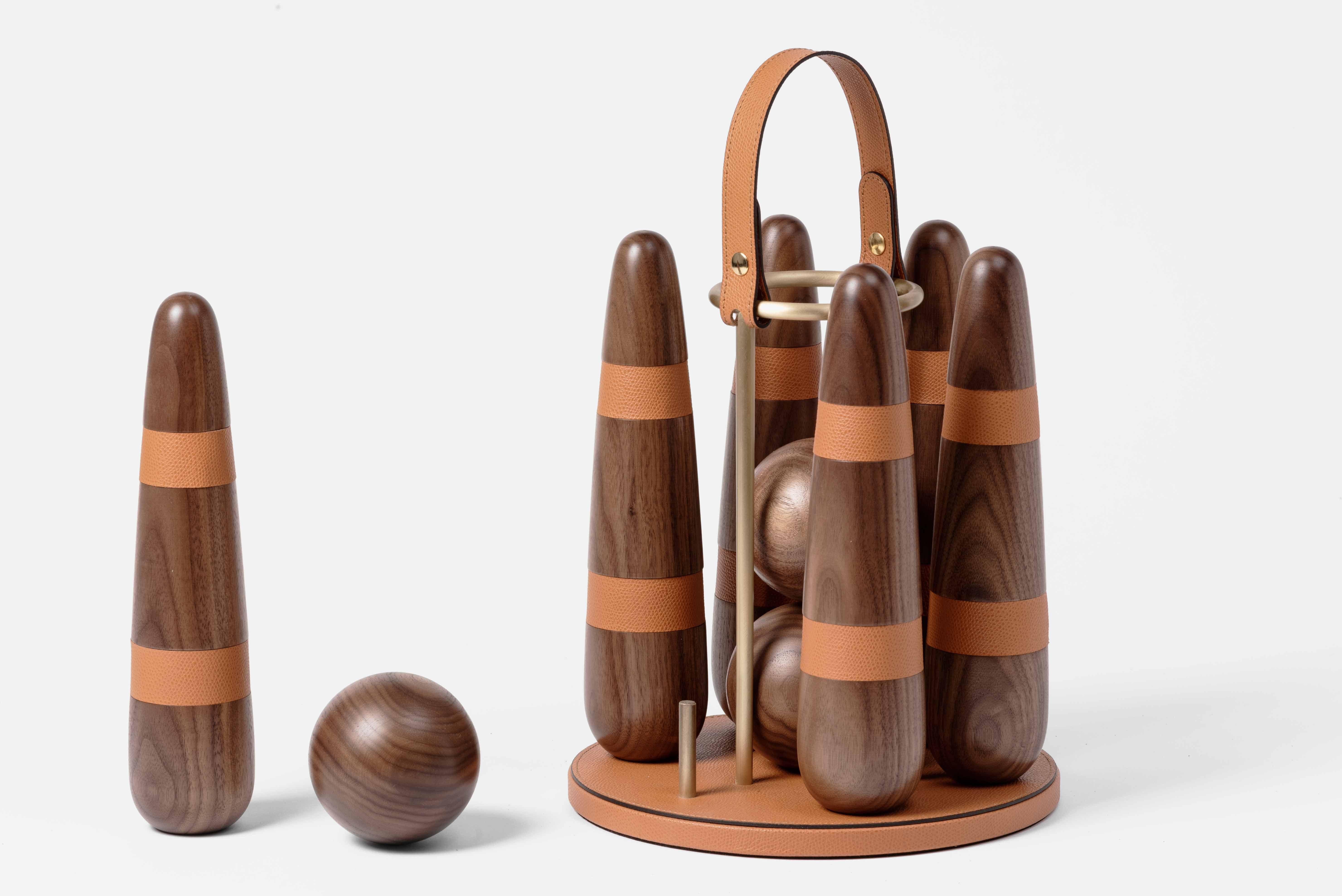 More than a game.

Masterfully handcrafted with precious canaletto walnut wood Pinetti portable Bowling set is enriched with leather details and satin brass finish. A sophisticated gift for any age or an ultimate statement piece for your home or