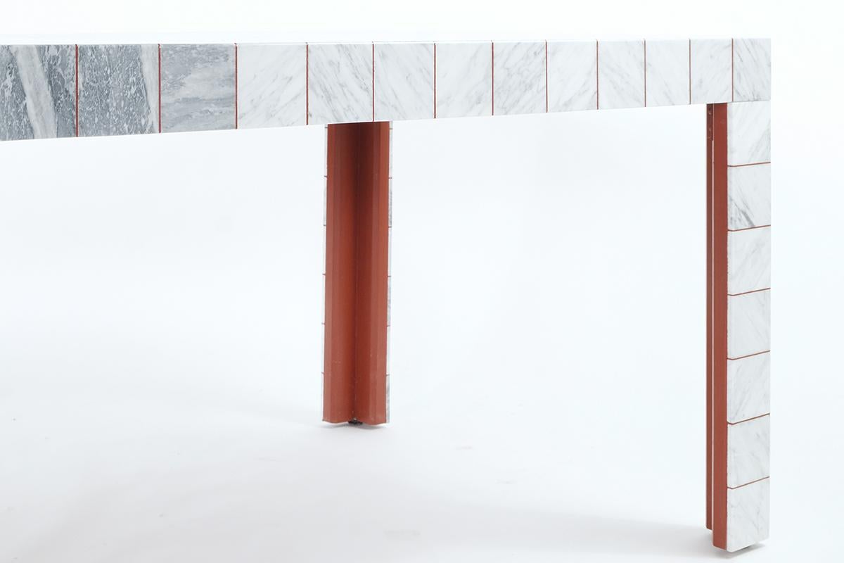 Polychrome marble low table
Size cm: 55 x 110 x H 36
Materials: Bianco Carrara + Bardiglio
Designer: G. Raboni & M. Montefusco

To preserve the Apuan quarries we have created this table using tiles of a common industrial format, enhancing the veins