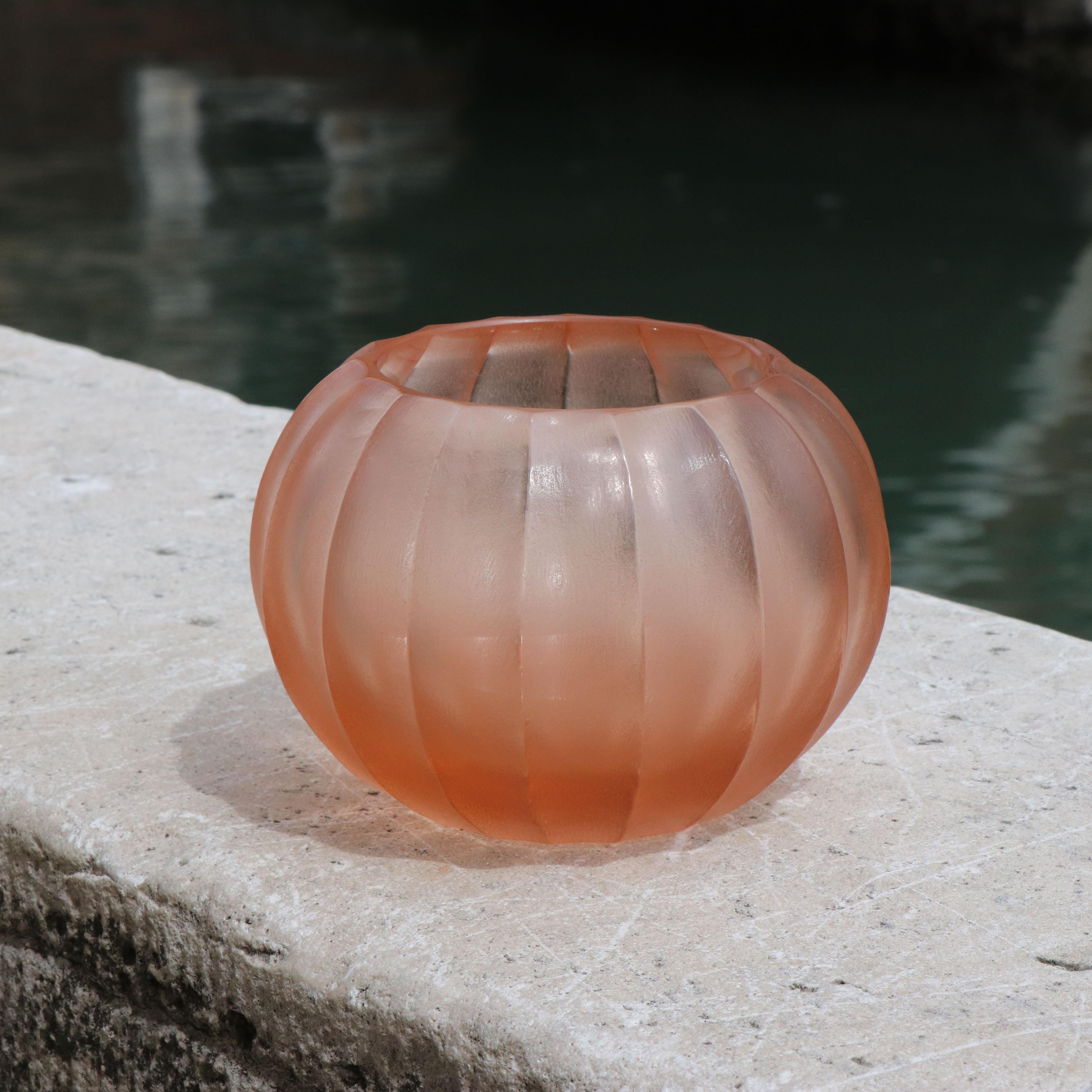 This small vase is called Bocia, a word from the Venetian dialect which means ‘little one’. Its round shape is achieved by first mouth blowing the molten glass. Once cooled the surface of the vase is finished with carving and polishing techniques