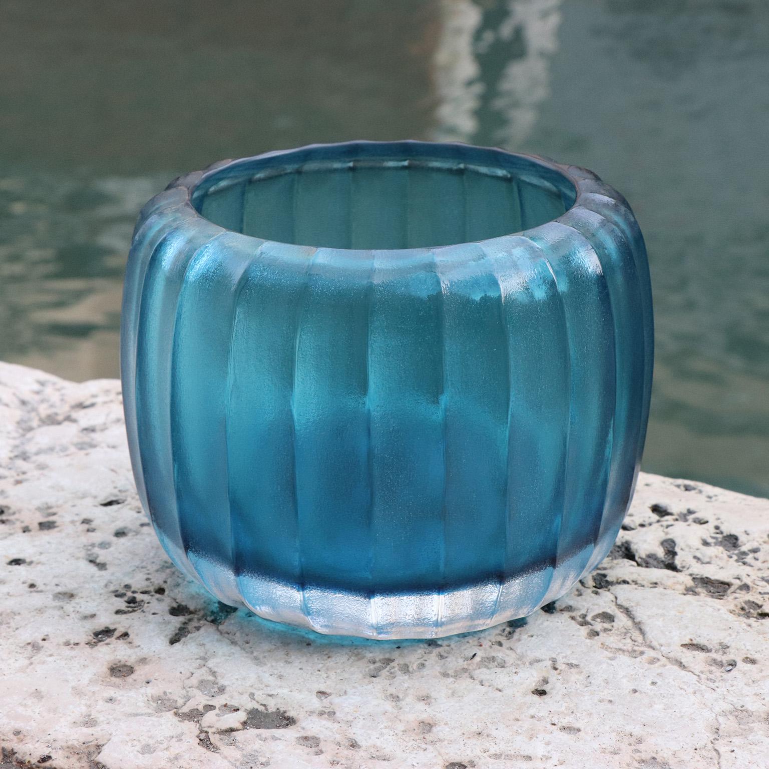 Defined by its sturdy, rotund body, the design of this vase recalls the Venetian water wells - Pozzo. Following the blowing process the vase is cold worked with carving and polishing techniques which completely transforms the visual and tactile