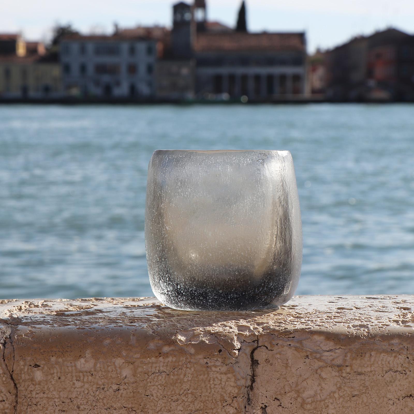 Defined by its sturdy, rotund body, the design of this vase recalls the Venetian water wells – Pozzo. Following the blowing process the vase is cold worked with carving and polishing techniques which completely transforms the visual and tactile