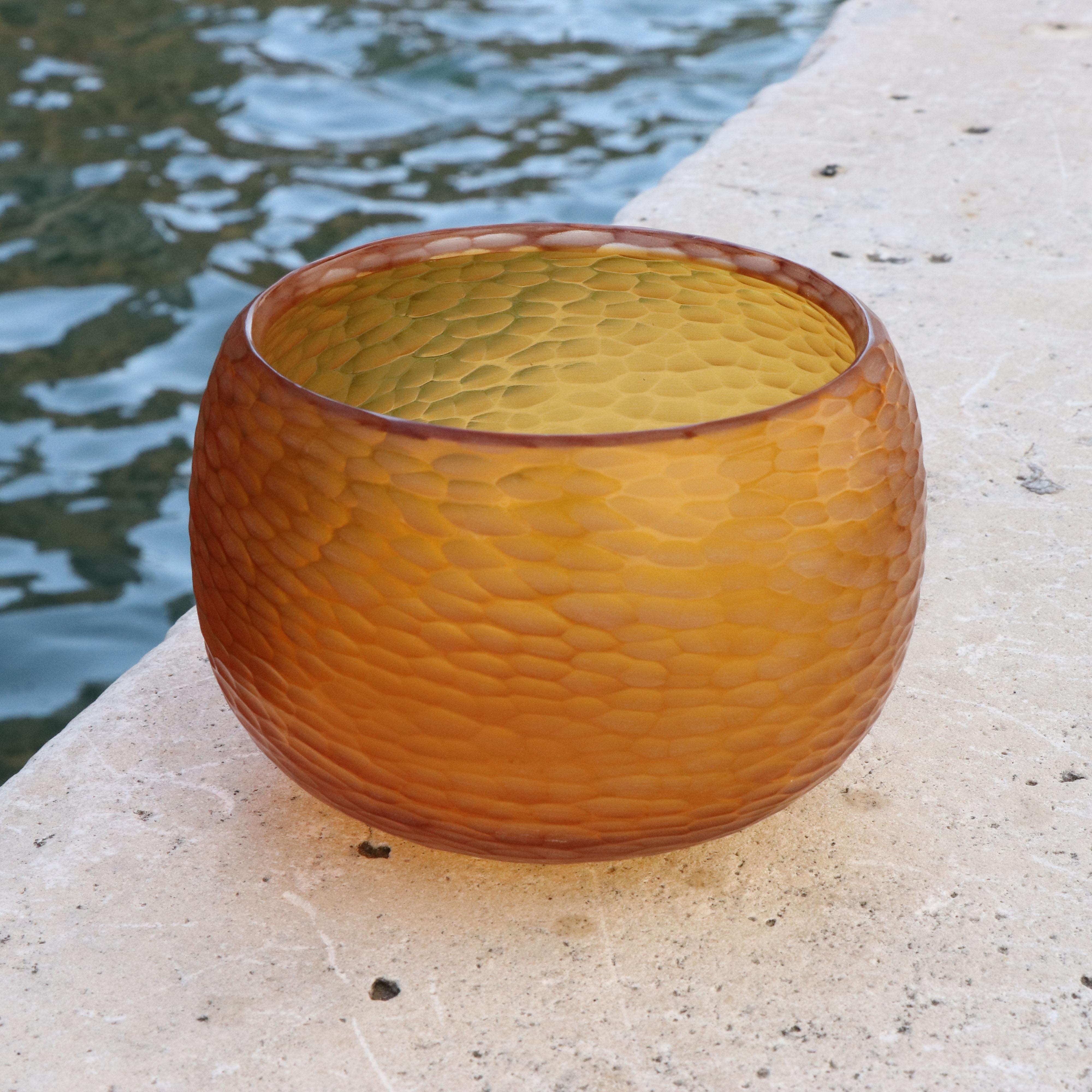 Playfully named Puffo this vase has a round ‘pouf-like’ shape. To achieve the desired form and dimensions the molten glass is first mouthblown. Once cooled the surface is transformed by a laborious cold carving process called ‘molatura’ lending the