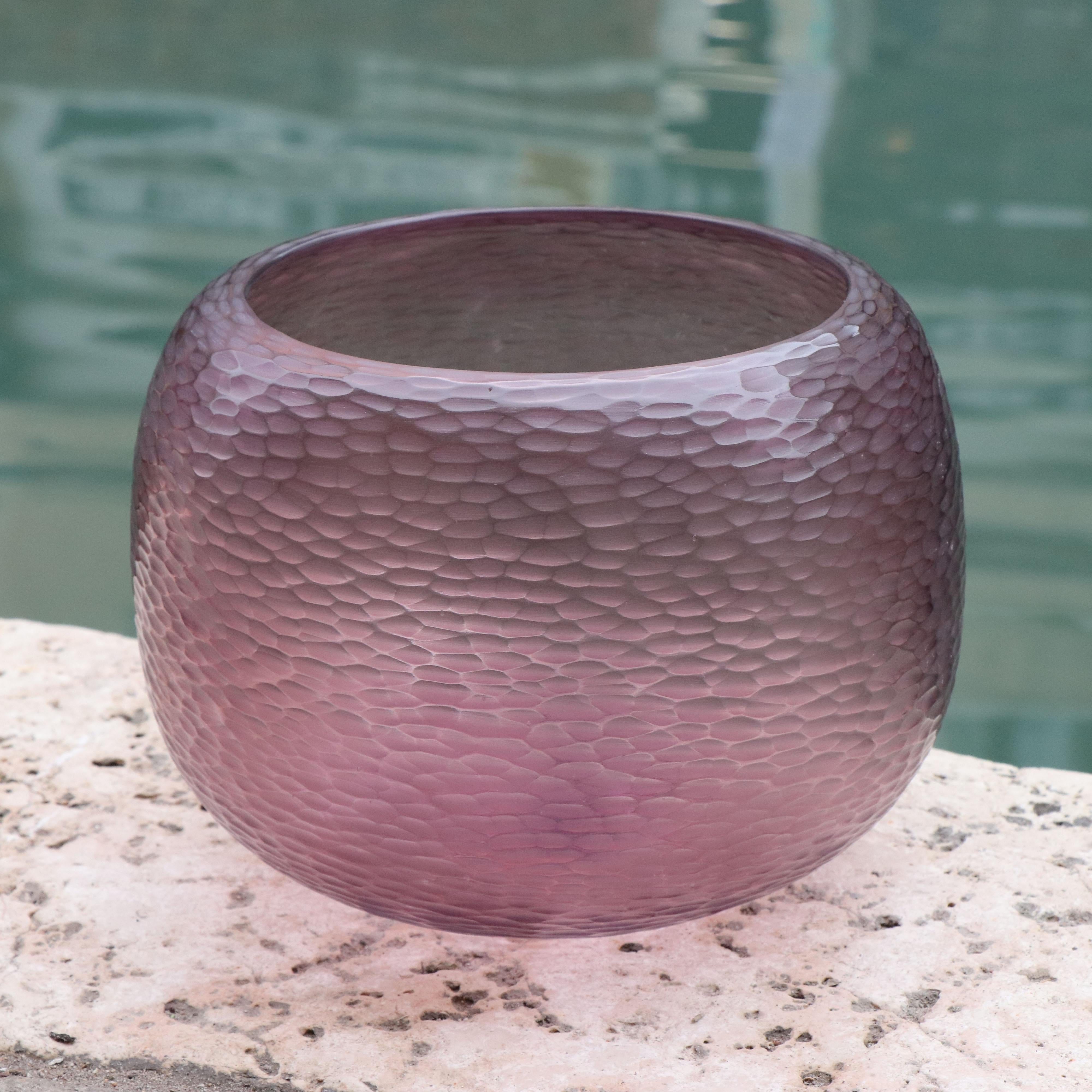Playfully named Puffo this vase has a round ‘pouf-like’ shape. To achieve the desired form and dimensions the molten glass is first mouthblown. Once cooled the surface is transformed by a laborious cold carving process called ‘molatura’ lending the