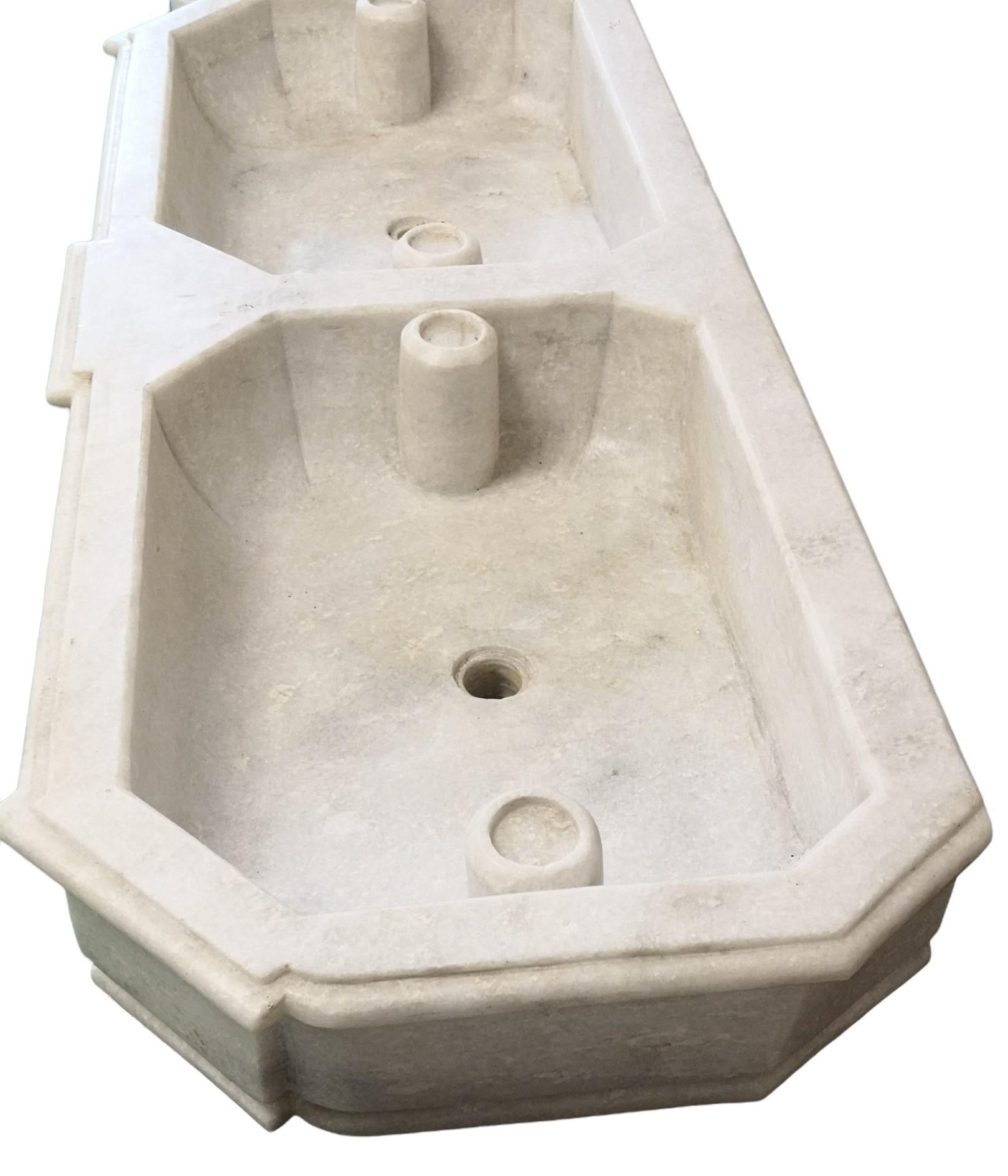 This timeless beautiful Italian classical double sink is cut from one single block of marble, the design has not changed since Greek and Roman times, it carries superb artistic merit easily fitting in with old and new buildings. It also makes an