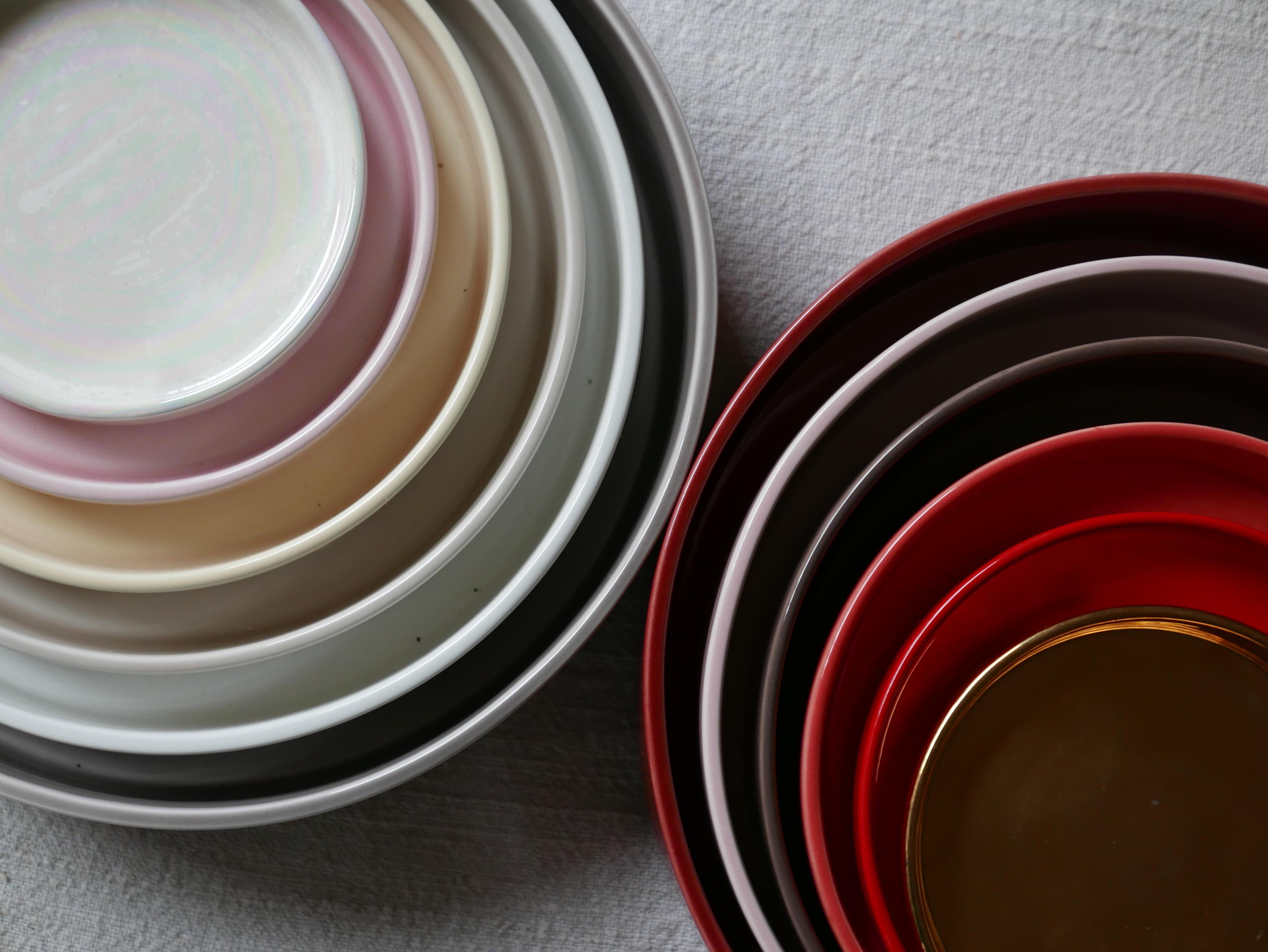 Milano Collection. Set  of 16 concentric ceramic serving round dishes - trays handmade and hand-decorated  of shades of 8 pieces in red and warm colors and 8 pieces in neutral colors, varying diameter and height, and that, once they are inside each