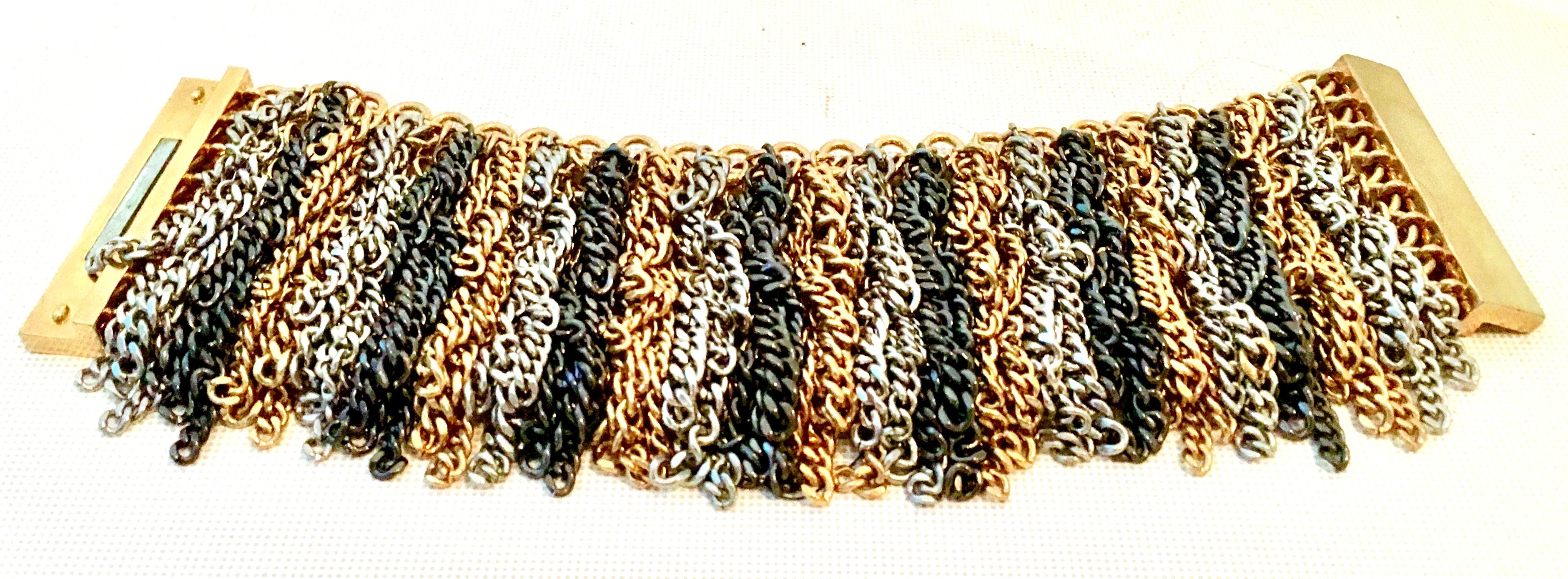 21st Century chain link 3-tone metal fringe bracelet. Features a magnetic close.
This piece is originally a Neiman Marcus piece and is unsigned.