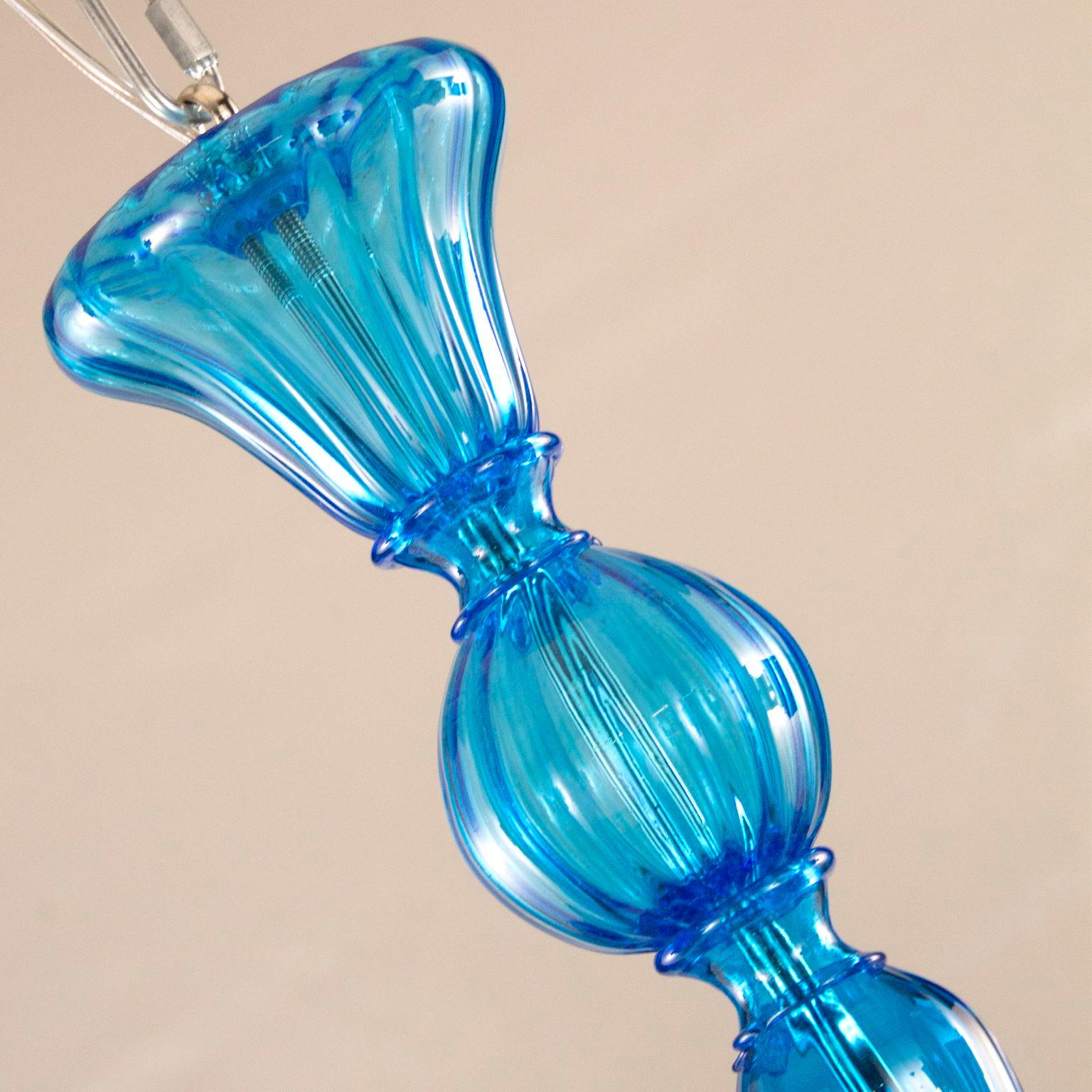 21st century chandelier 6 lights upwards, rigadin texture turquoise color Murano glass by Multiforme.

This chandelier evokes the atmosphere of the beginning of the 19th century. The cups give this product a peculiar lightness of volumes. The glass
