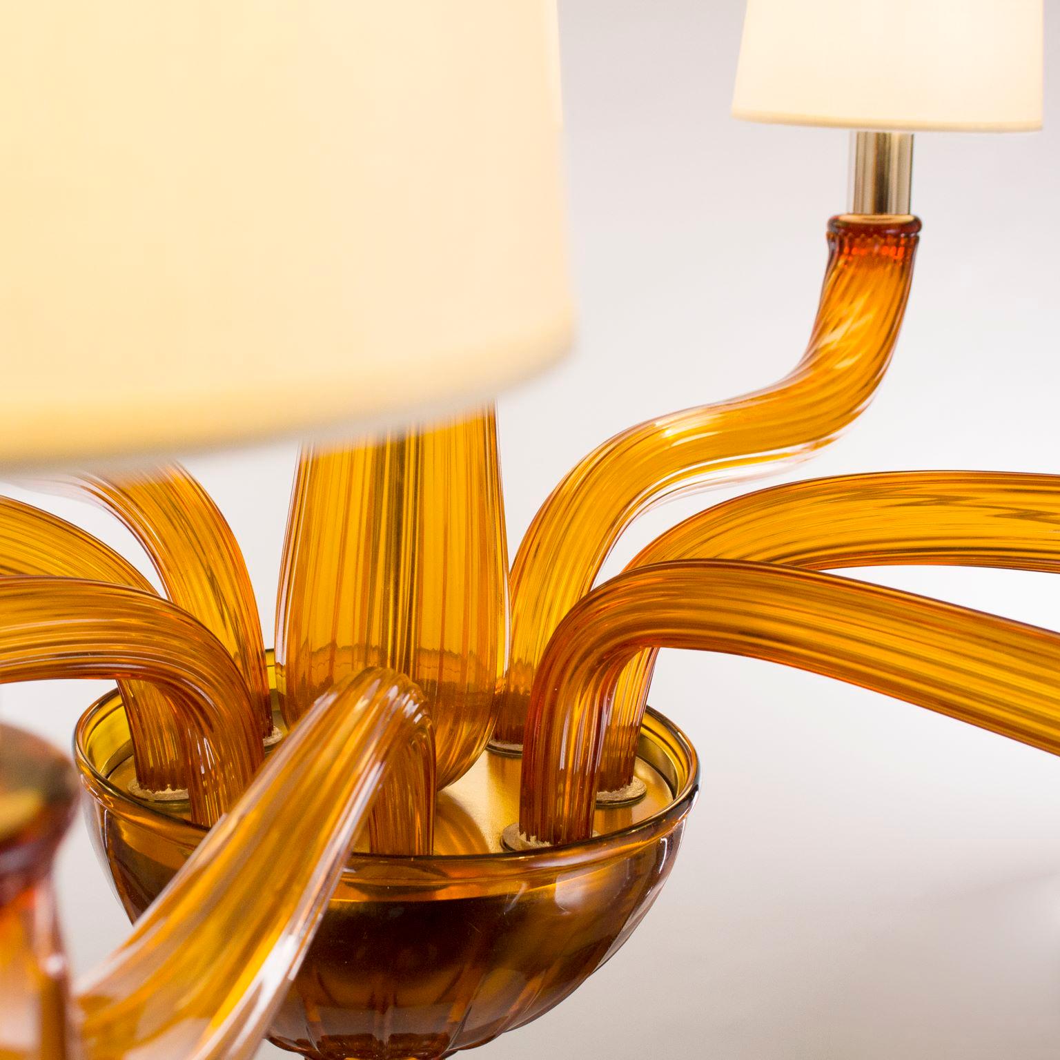 Coco chandelier 8  light artistic amber Murano glass, white lampshades by Multiforme
The glass chandeliers Coco collection takes inspiration from Coco Chanel, the revolutionary woman that has changed the fashion industry during the 1920s.
In