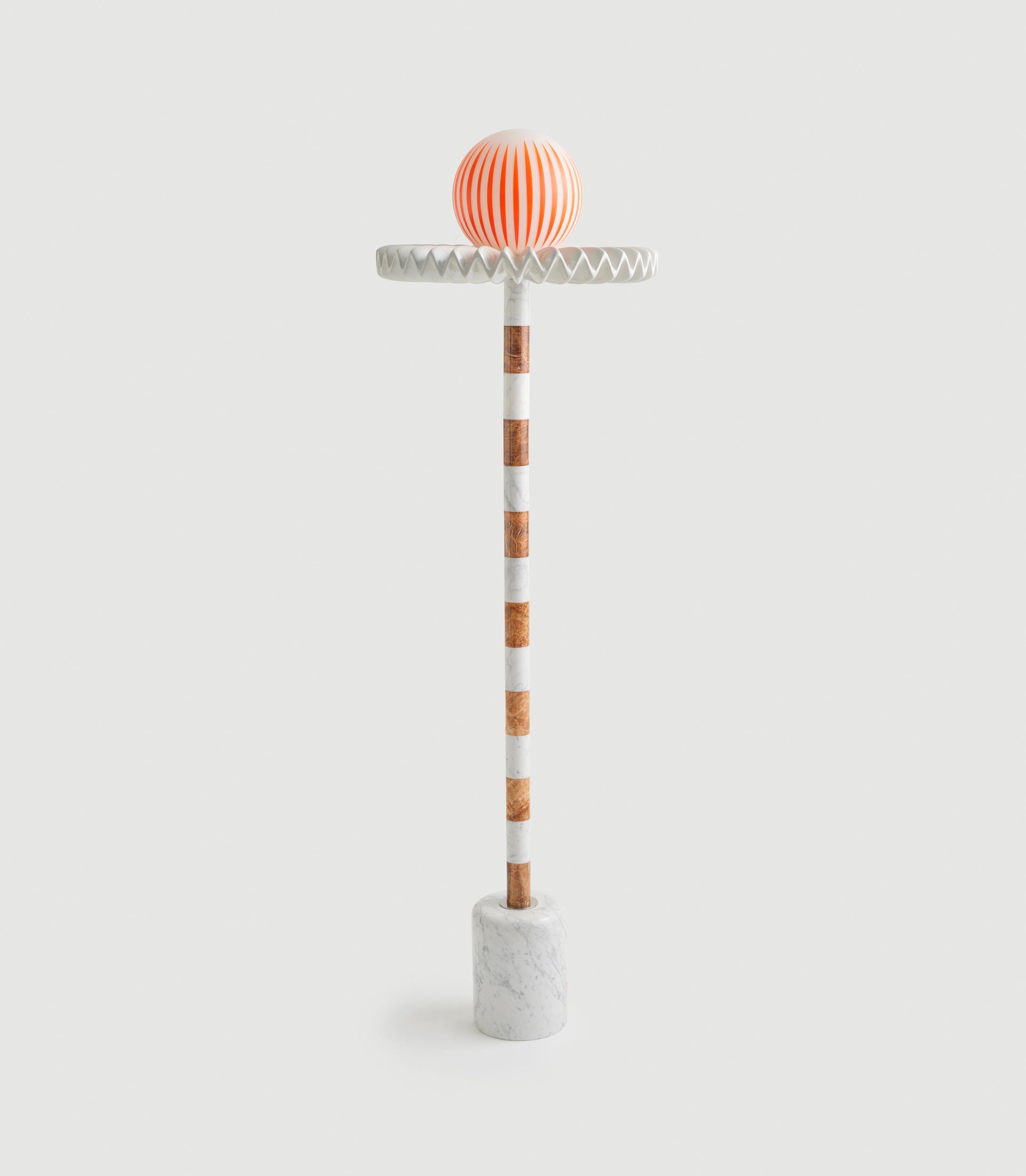 “Sare” is a floor lamp inspired by the 17th century ruff collar which was a symbol of wealth and status. It also resembles the silent clown “Pierrot” with it’s striped marble body and round glass head. Sare is handcrafted and assembled with