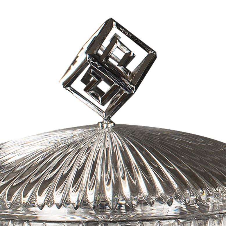21st century, clear hand-carved crystal, chromed bronze  box with intricate detailing and a bold geometric style. The domed lid features a radiant sunburst pattern, topped with a unique double-square handle that recalls classic Art Deco motifs. The