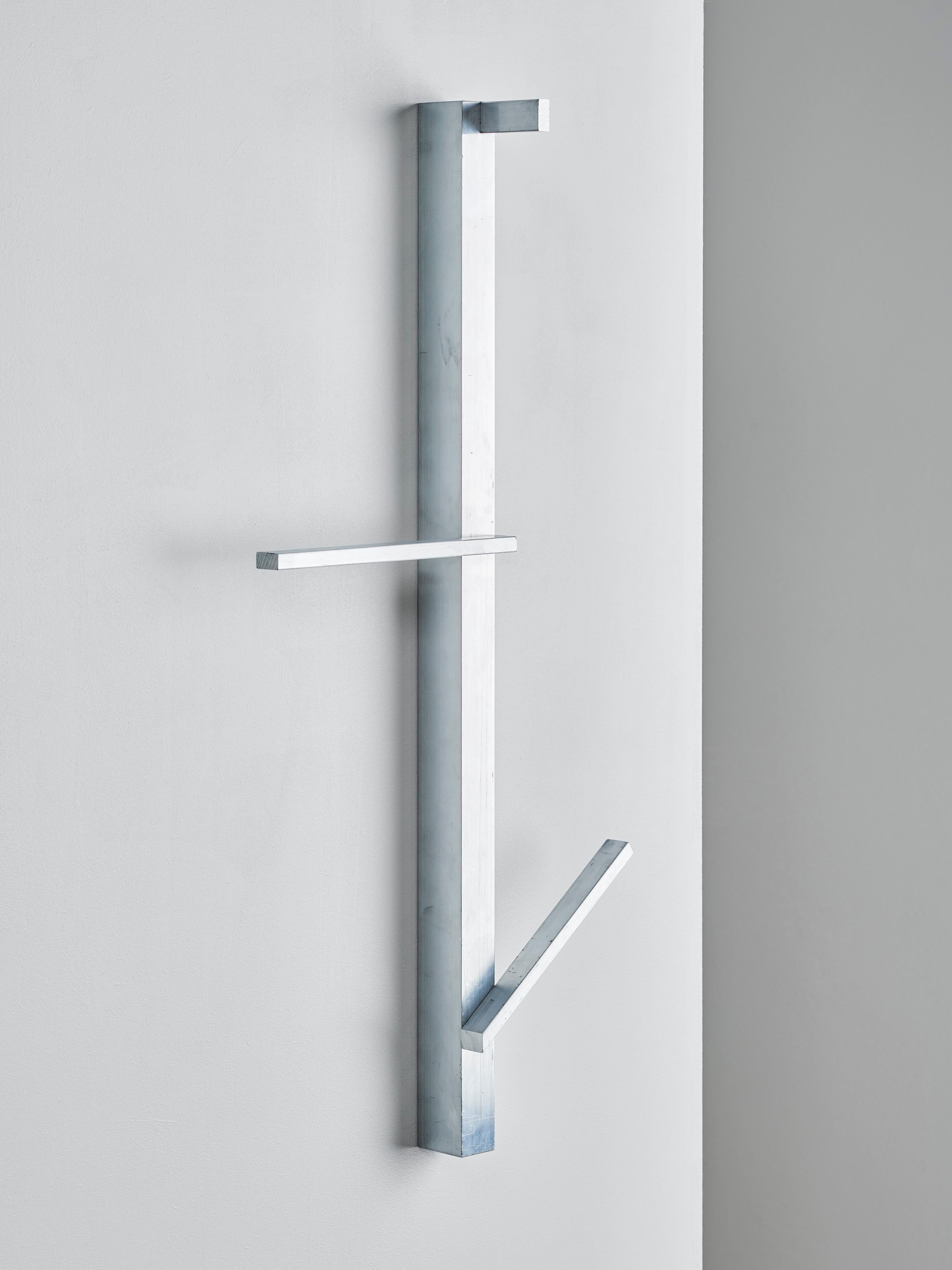 Valet serves as a hanger for clothes, towels or bags in the entryway of your home, the bath- or bedroom.
Three pieces of aluminium with differing inclinations are mounted on a vertical aluminium profile at three different heights to insure a