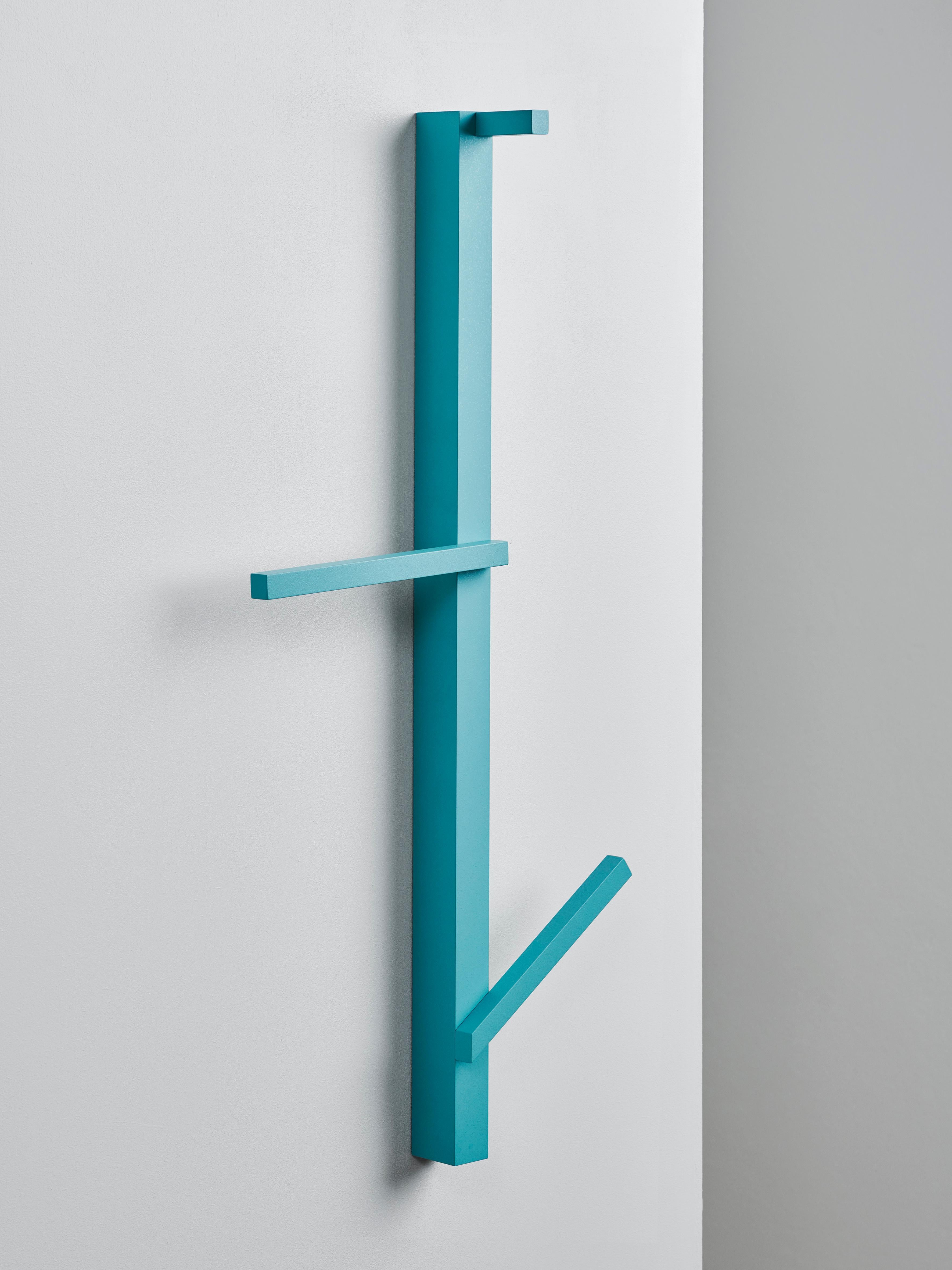 Valet serves as a hanger for clothes, towels or bags in the entryway of your home, the bath- or bedroom.
Three pieces of aluminium with differing inclinations are mounted on a vertical aluminium profile at three different heights to insure a