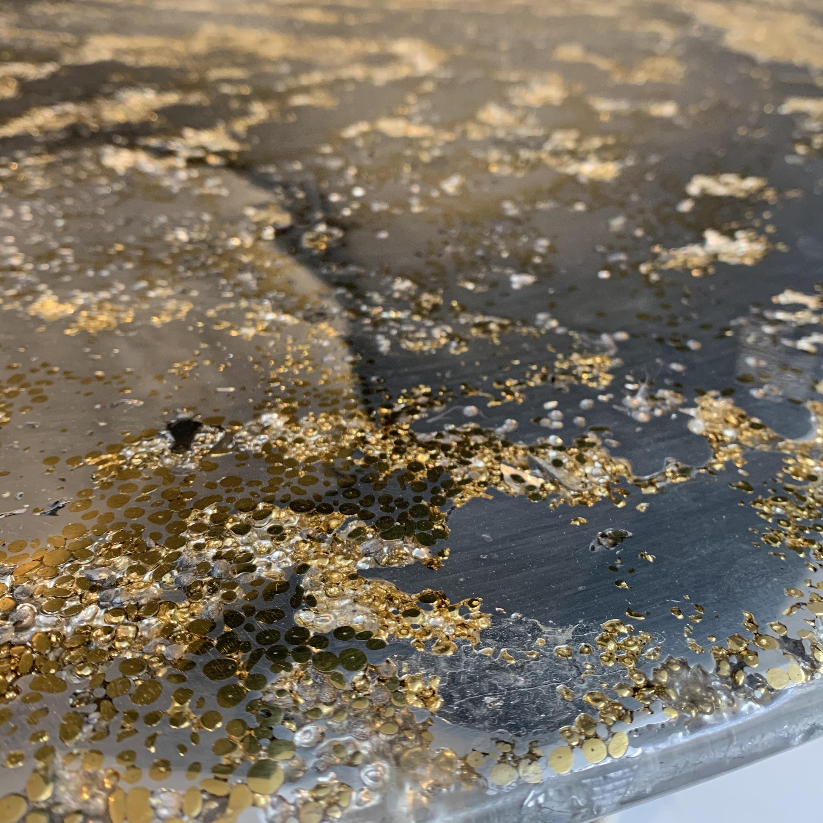 This contemporary coffee table is a unique piece, created by Xavier Lavergne and made of melted pewter with brass grains, embedded in resin and polished like a marble. The table is handmade in France. Each piece is unique and sold with its