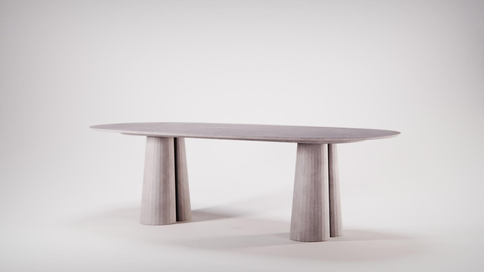 A new addition to the Fusto Line: oval shaped dining table part of a collection of modular system in ultra-high performing cement mortar. UHPC tabletop and base colored in the mixture and sandblasted. Available in eight different colors: Brick,