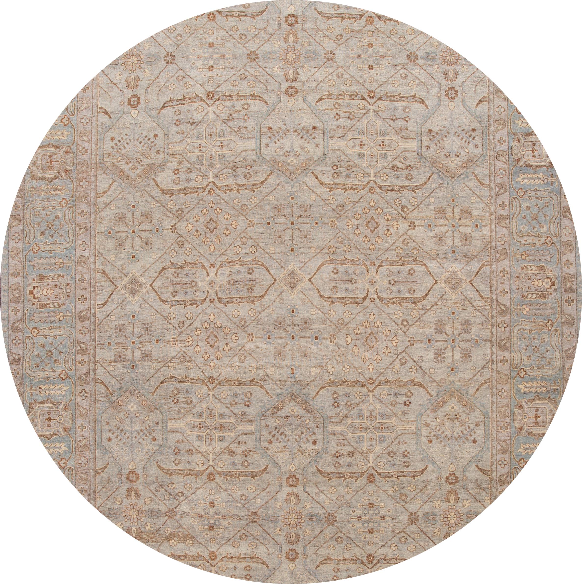 Beautiful modern hand knotted Indian wool rug with a gray field, beige, brown, and blue accents with an all-over geometric design.

This rug measures: 9'8
