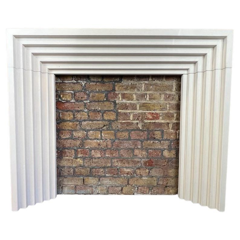 21st Century Contemporary limestone fireplace mantlepiece.
Based on an Art Deco Style. This six stepped fireplace offers a very contemporary feel. Made in a light natural limestone and hand carved.

Dimensions:
shelf width 57 inches
shelf depth