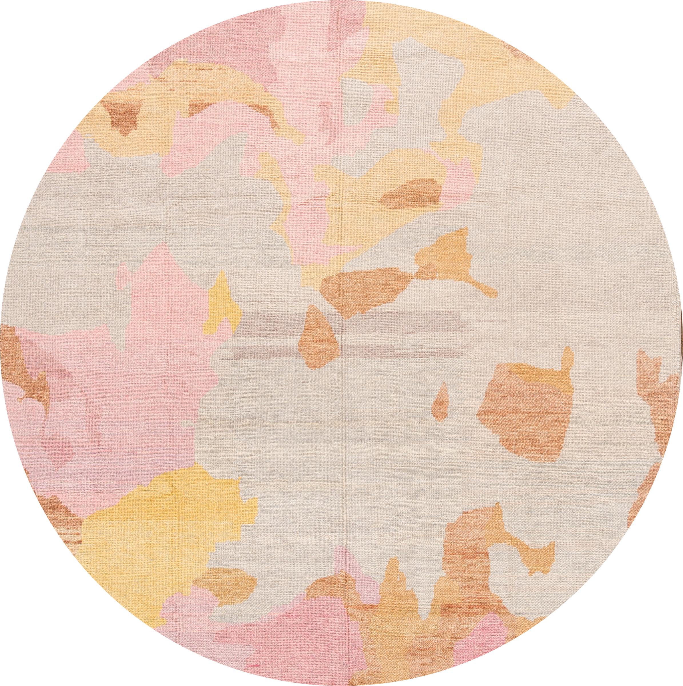 Beautiful contemporary Turkish designer rug, hand knotted wool with a tan field. Accents of pink, brown, and yellow in all-over abstract design,

This rug measures: 8'1” x 9'10”.