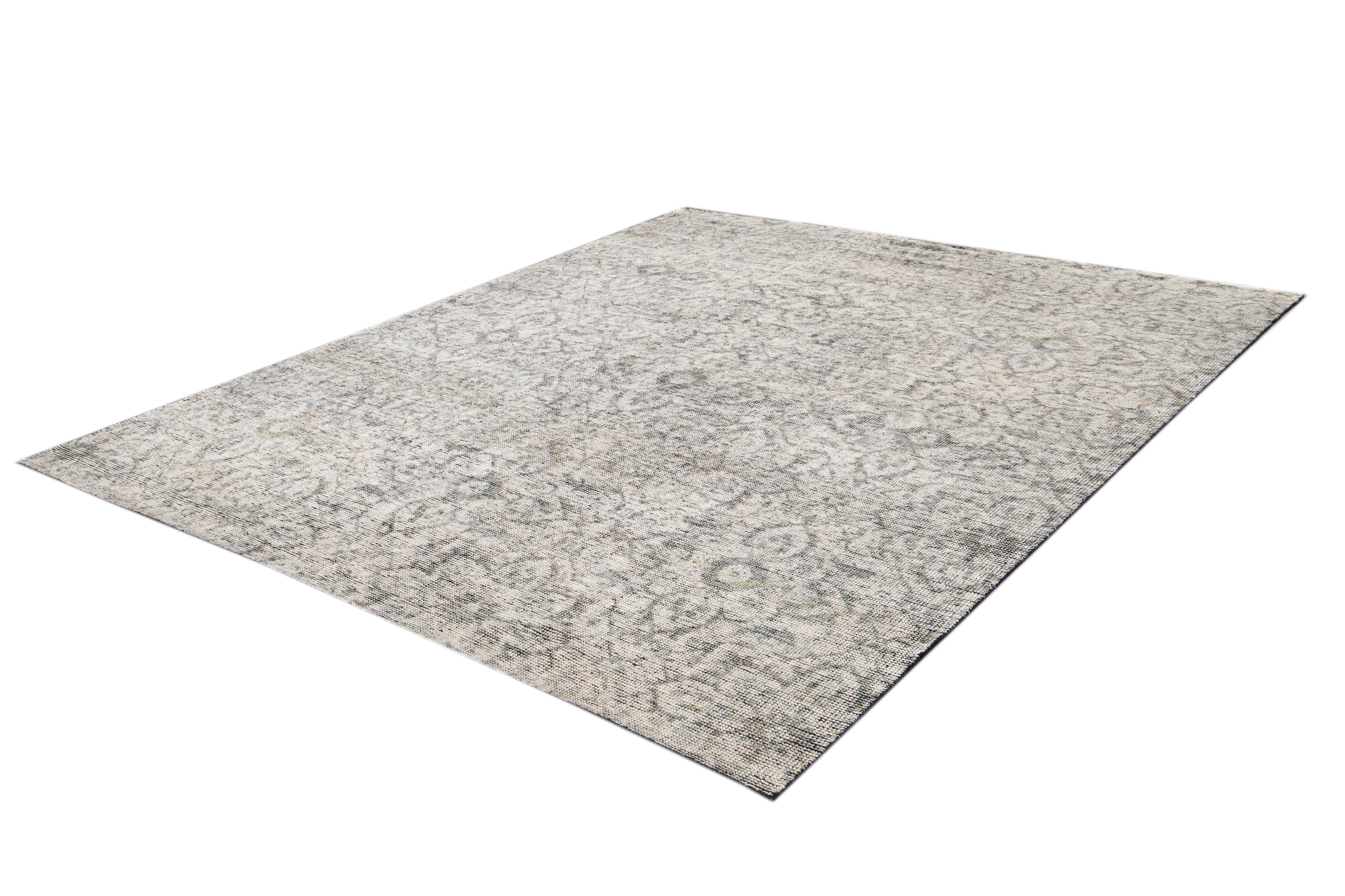 Beautiful Modern Soumak Style Distressed Indian Rug, hand-knotted wool with a gray field tan and light blue accents with an all-over floral medallion design. 

This rug measures 8' 0