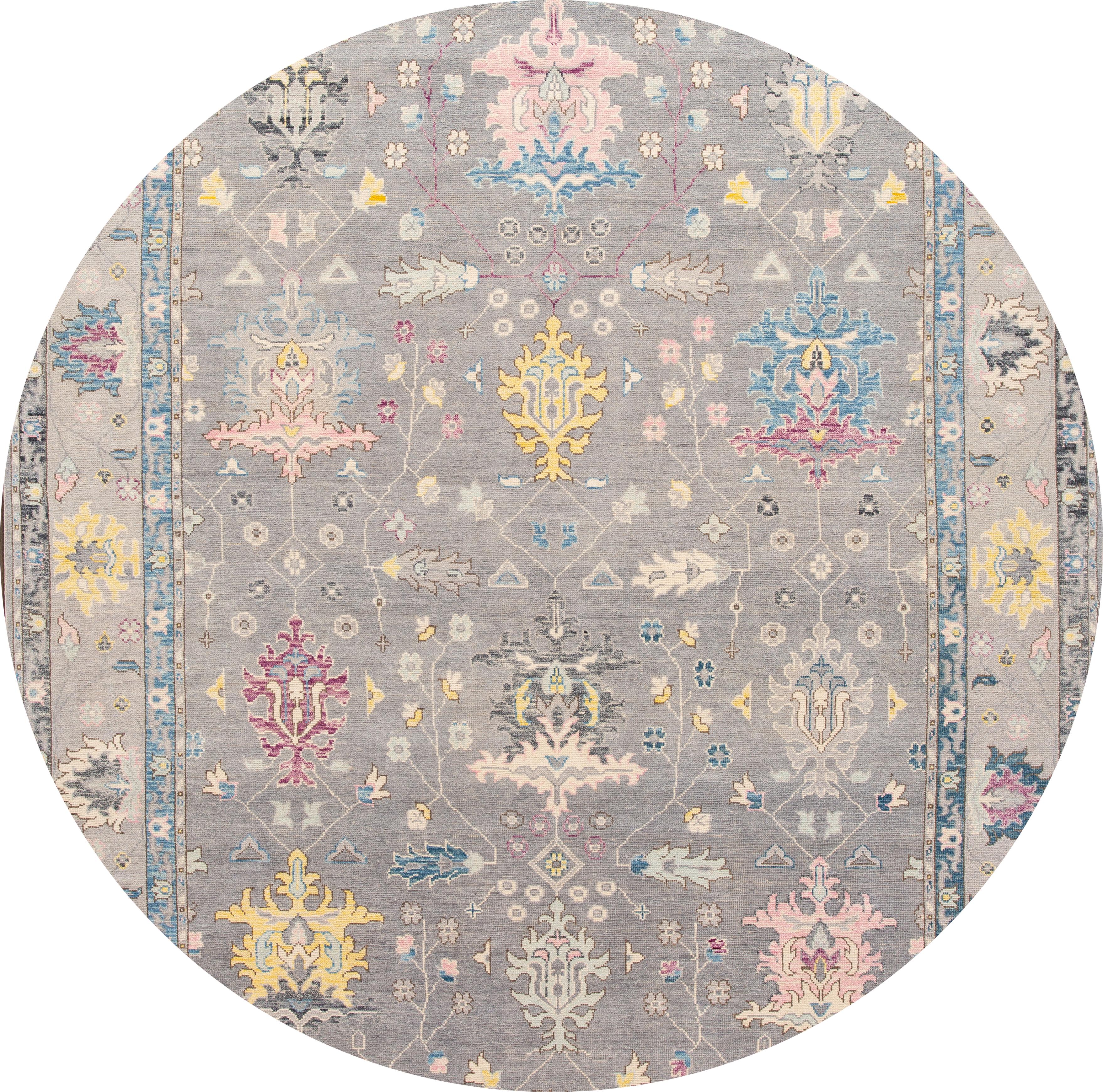 Beautiful contemporary Oushak rug, hand knotted wool with a gray field, and multi-color accents in all-over floral design,

This rug measures: 10'2