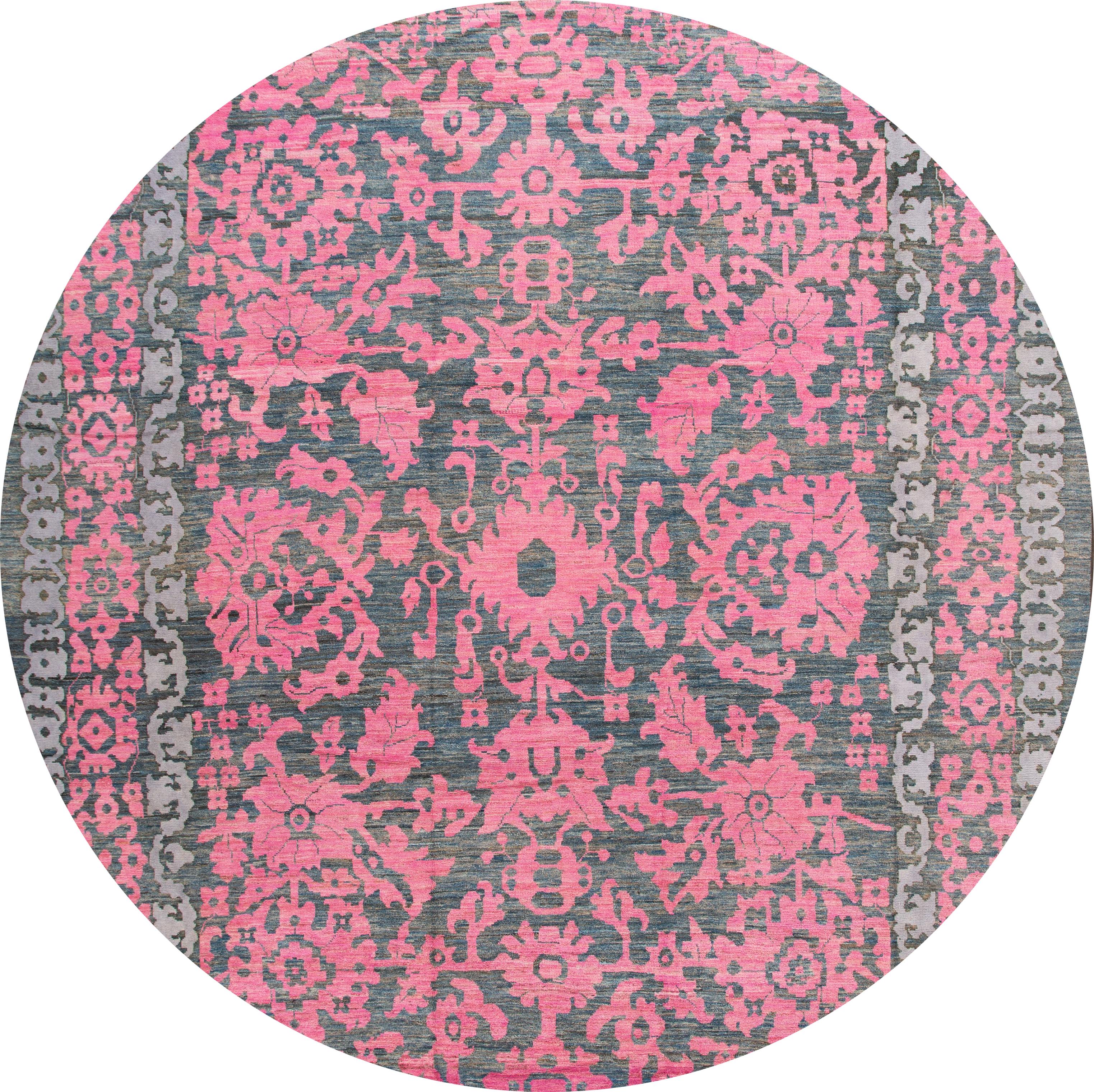 Beautiful contemporary oversize Oushak hand knotted wool rug with a botanical floral design on a gray field. Accents of pink throughout the piece. 

This rug measures 13' 5