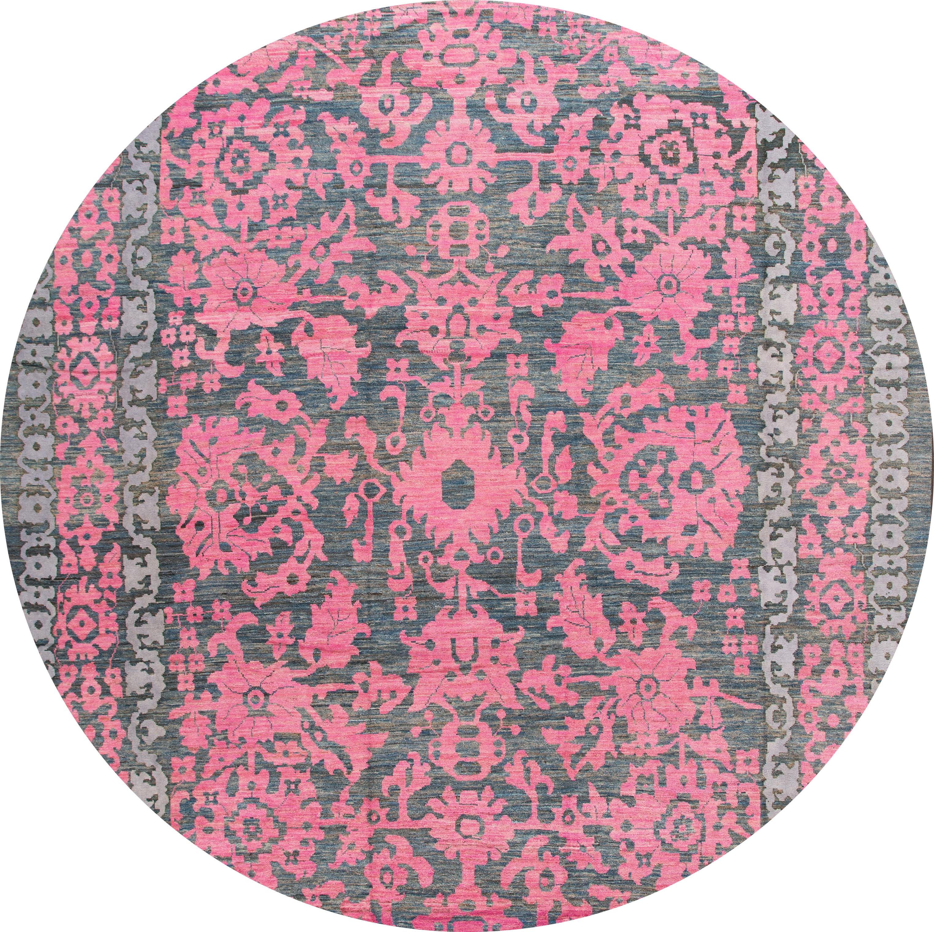 Beautiful contemporary oversize Oushak hand knotted wool rug with a botanical floral design on a gray field. Accents of pink throughout the piece. 

This rug measures 13' 5