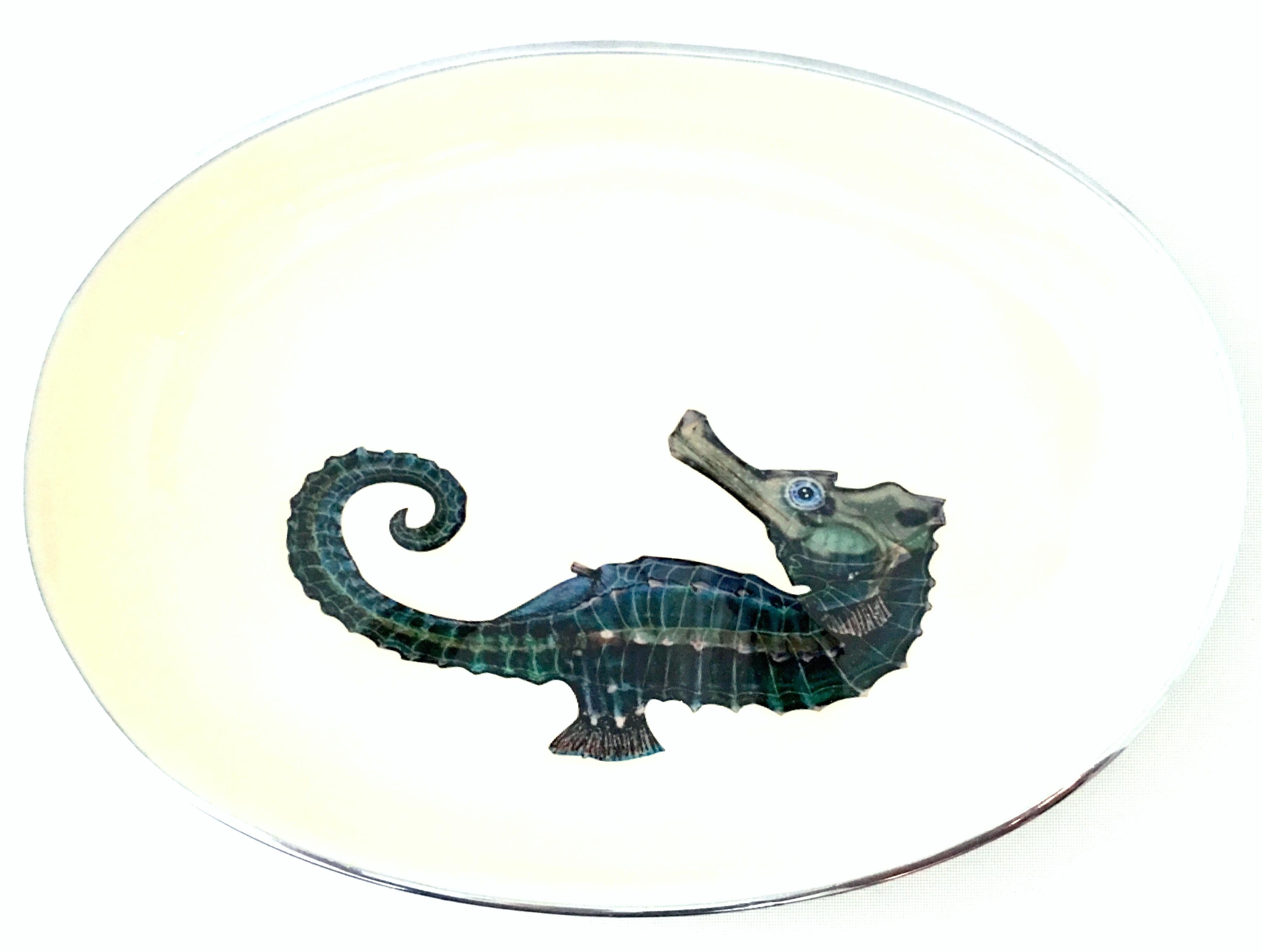 21st Century silver & enamel sea horse motif oval bowl. This multi purpose decorative or serving bowl features, a substantial weighted aluminum base with a enamel hand painted sea horse motif in shades of green, teal and brown on a creamy yellow