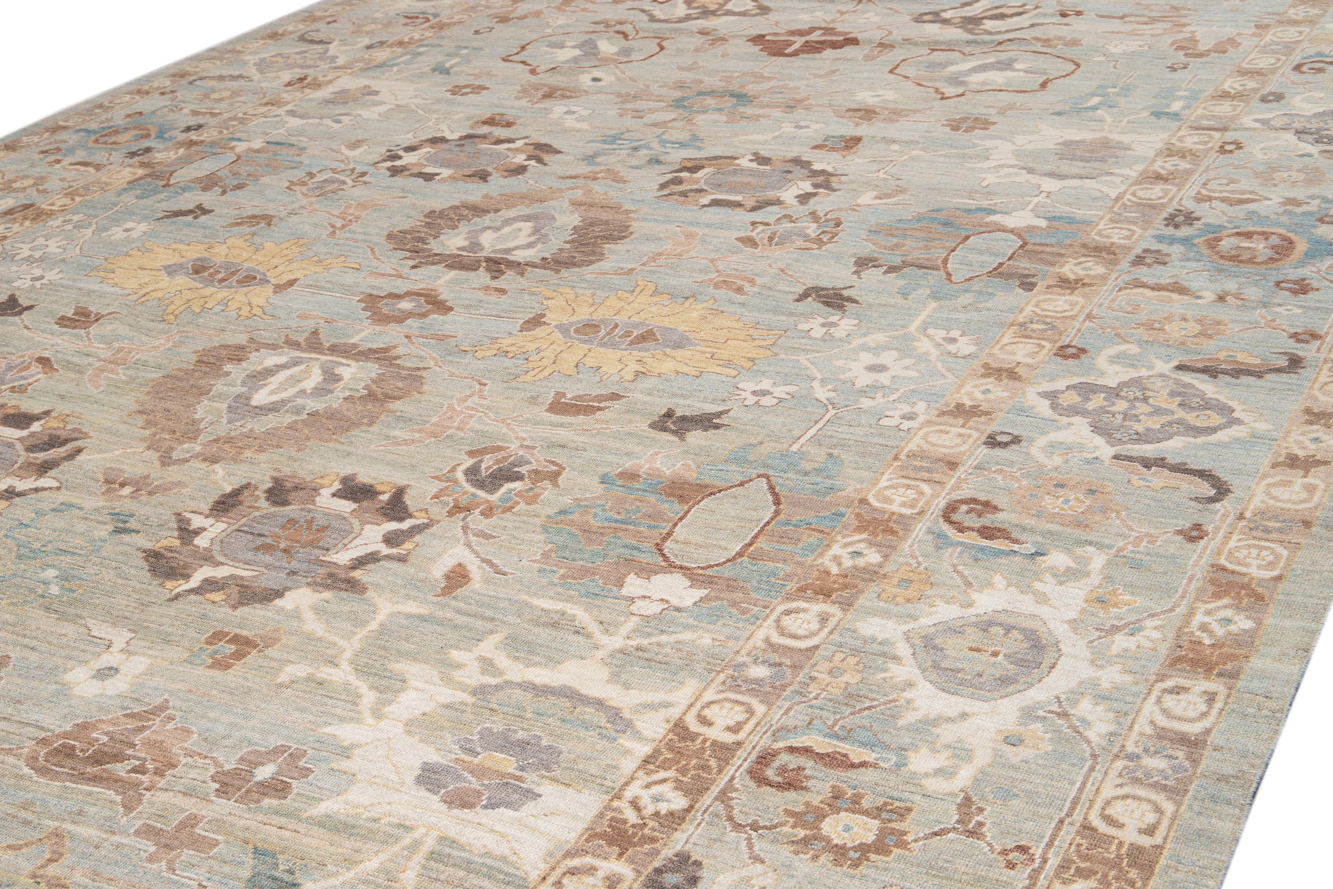 Beautiful modern Sultanabad rug with a light blue and beige field with multicolored accents and all-over floral design. 
 
This rug measures 13' 3