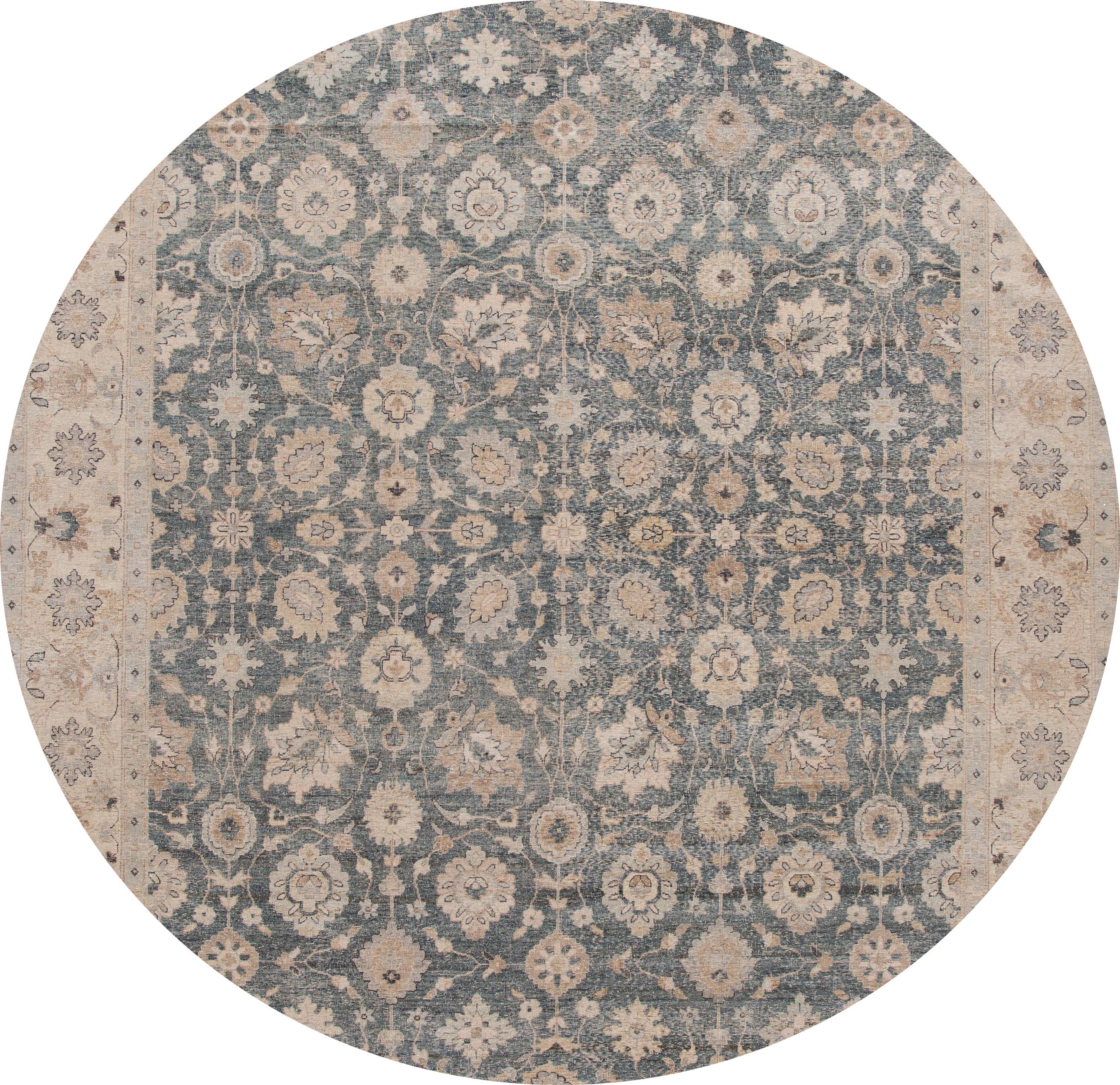 A contemporary Tabriz-style rug with an ivory field and blue accents in a symmetrical, interconnected floral and vine design. This hand knotted wool.
This rug measures 9'11” x 13'10”.