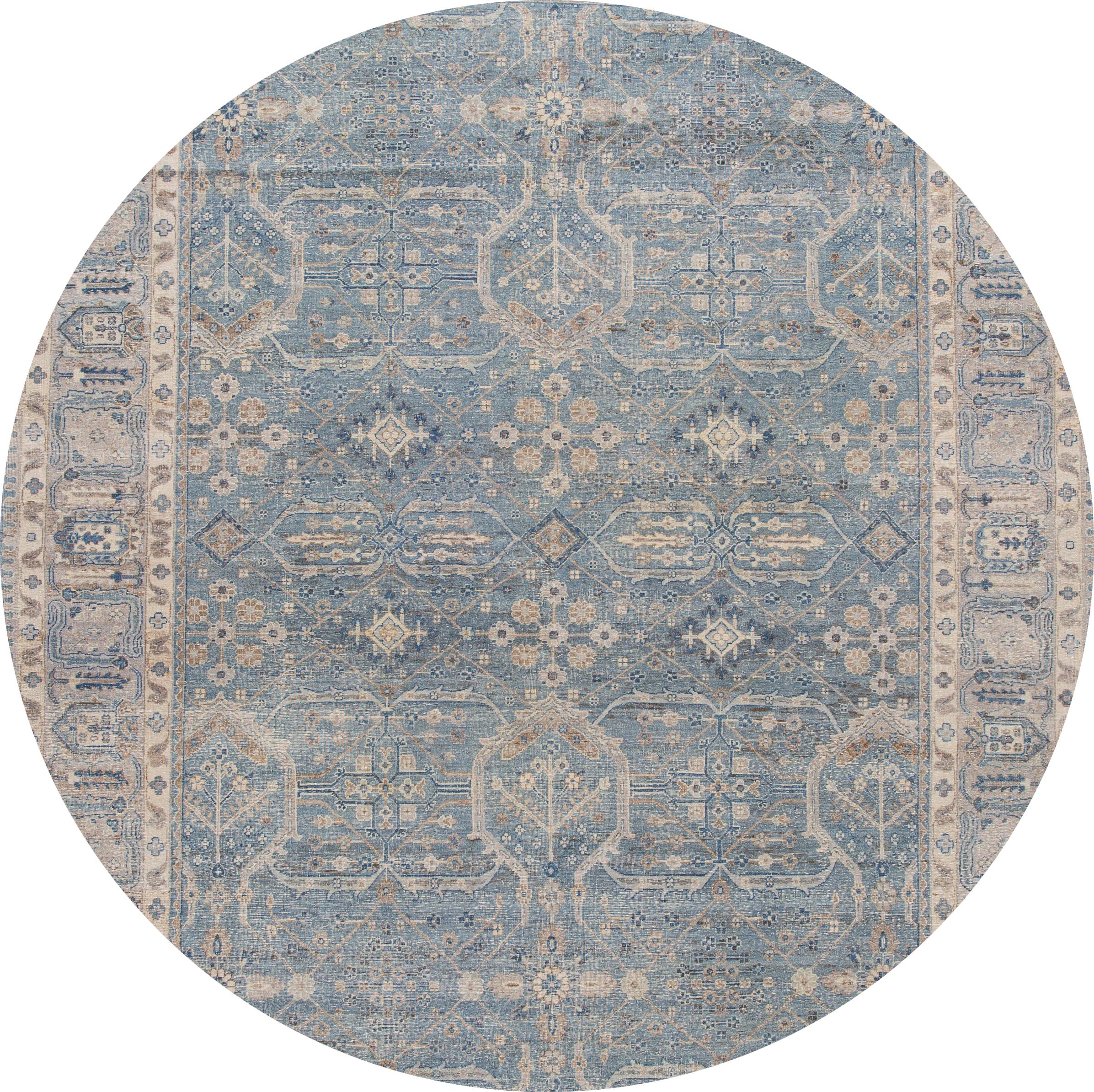 A contemporary Tabriz style rug with a tan field and ivory and blue accents in a symmetrical, interconnected floral and vine design. This hand knotted wool.
This rug measures: 9