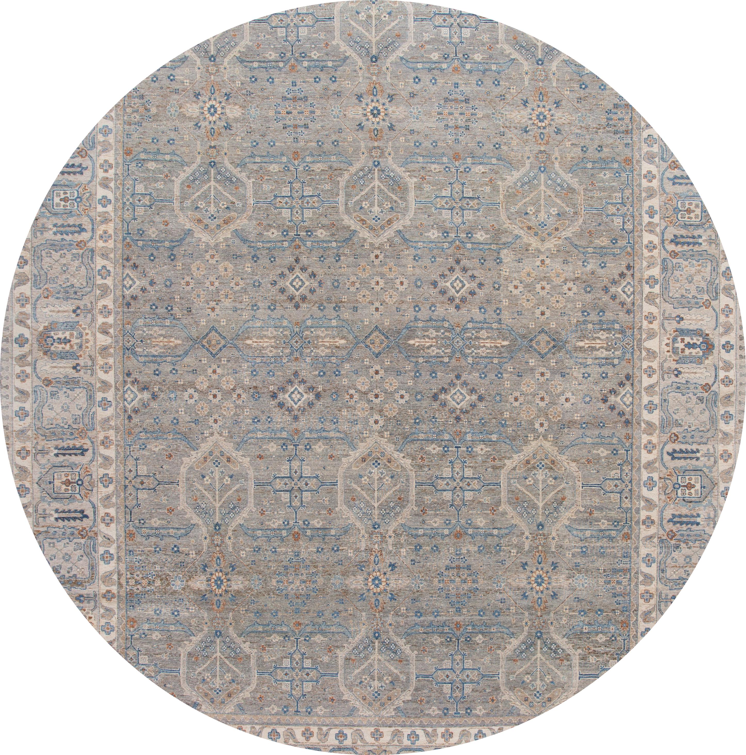 Beautiful modern hand knotted Indian wool rug with a gray field, blue, brown, and ivory accents with an all-over geometric design.

This rug measures: 11'11