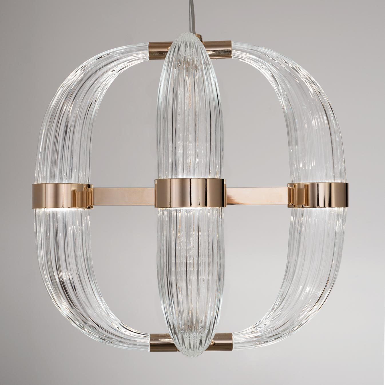 Love at first sight between glass and metal. A light cascade suited for a vertical or horizontal development, according to the needs. One, two or many elements. The imperfect, organic and sinuous lines of the hand blown glass are contrasted by a