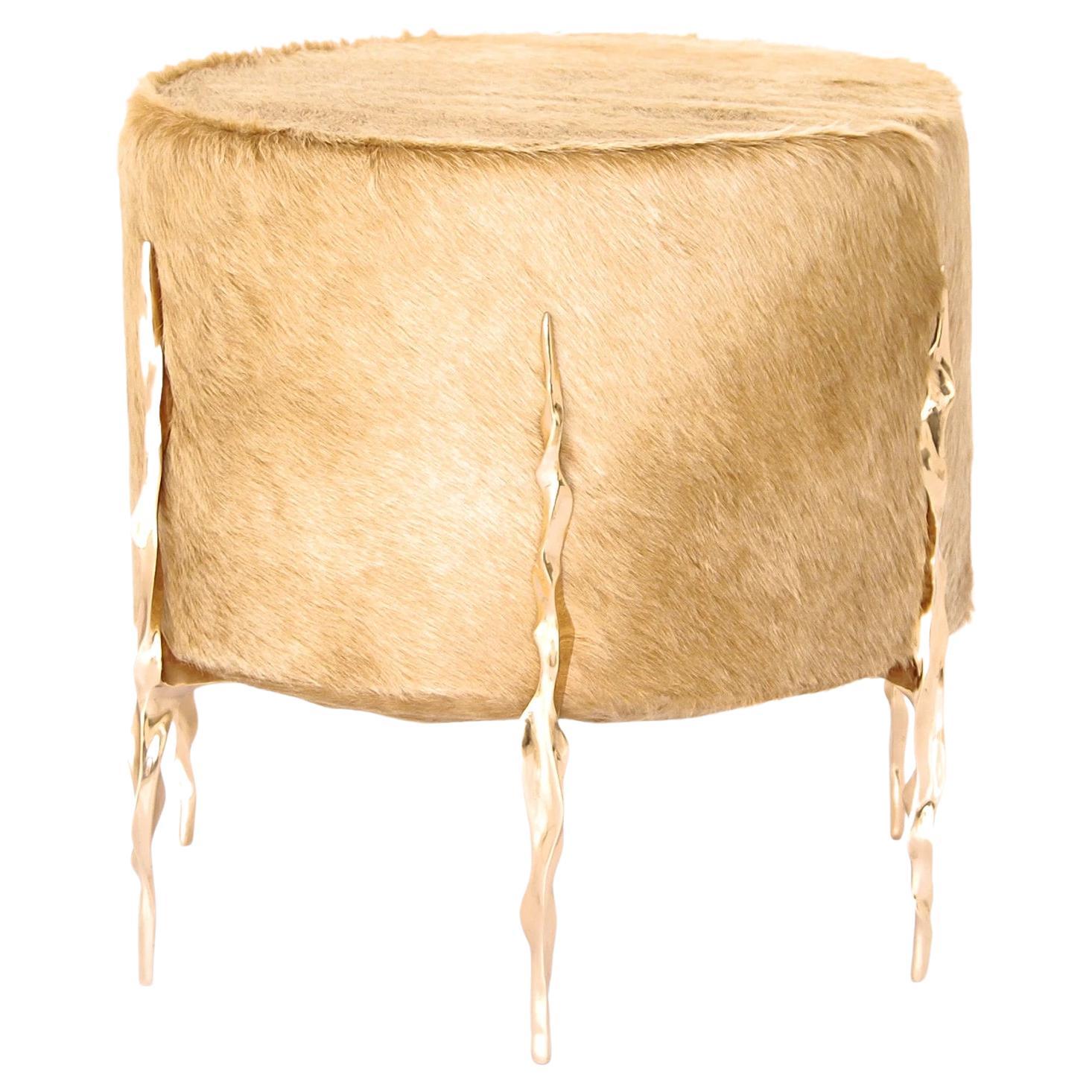 The timeless aesthetic and durability of cowhide meets the modern edged signature Fakasaka styling with 6 spear headed hand molded and carved polished bronze legs, creating the fierce Ava Ottoman.

Hand made to order, this Ottoman is also